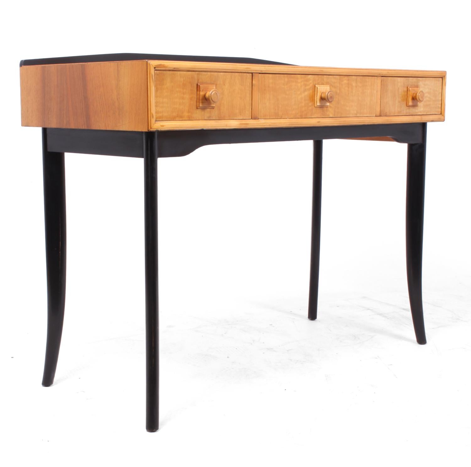 Midcentury console table, circa 1960.
A British midcentury console or side table with three drawers in maple with ebonised legs and back up-stand, this is by unknown maker but good quality with dovetail joint construction, the console table has