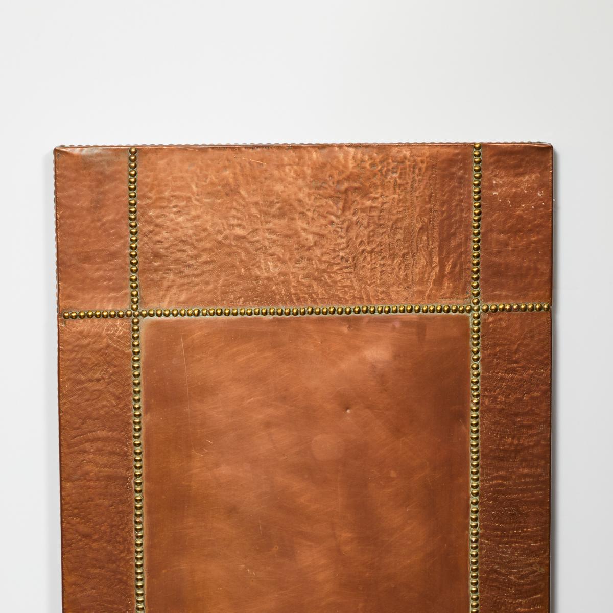 Textured copper and brass riveted panel from mid-century France. A piece of art in its own right, the panel has a unique texture reminiscent of webbing. Stylistically it has shades of art deco, the arts and crafts movement, and the modernist