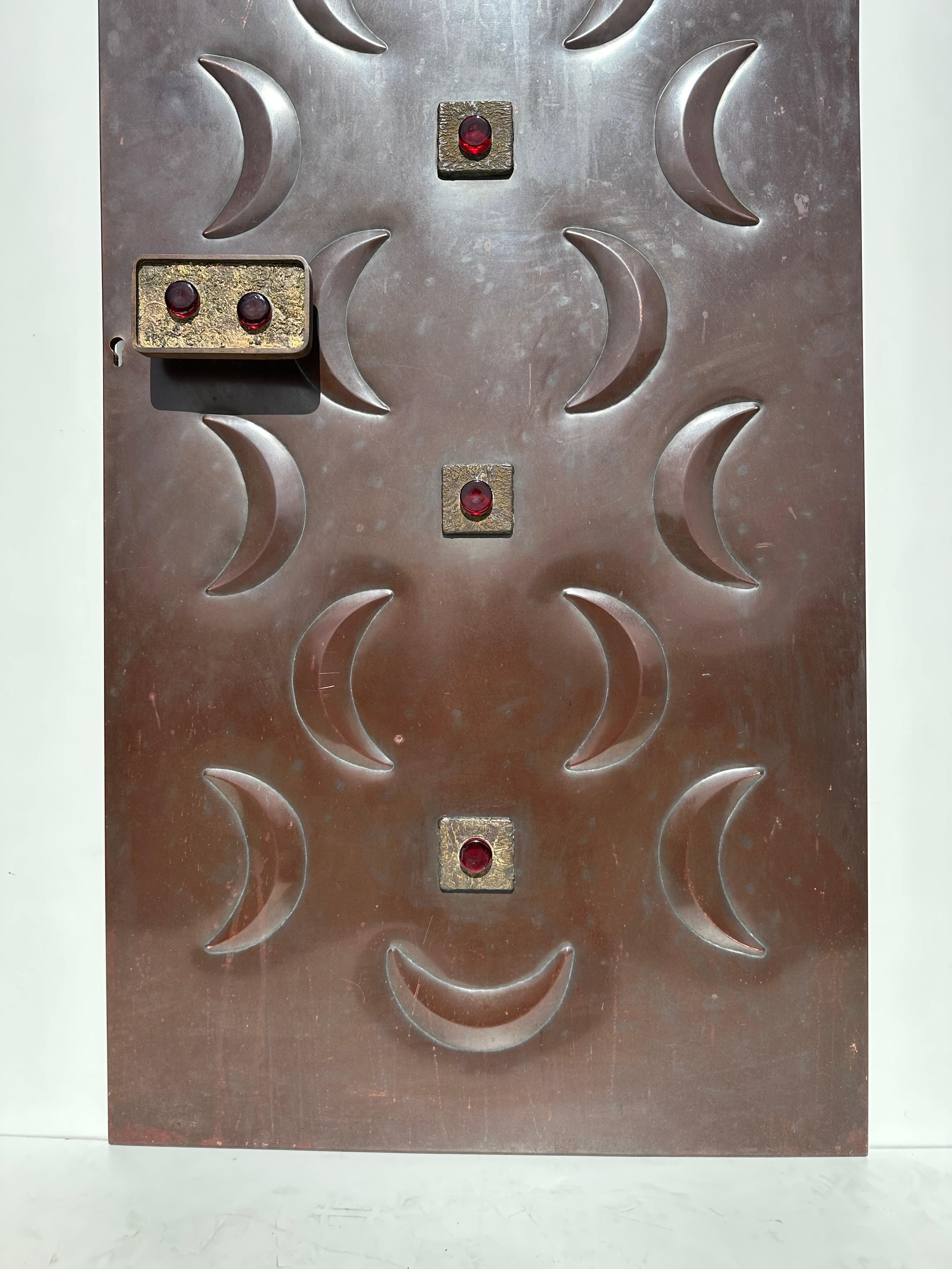 Handcrafted repousse copper door with cast bronze handle and details with cast glass ornaments. This panel can be attached to your existing door or have your contractor build a new door incorporating the copper panel.
Or simply use as a decorative