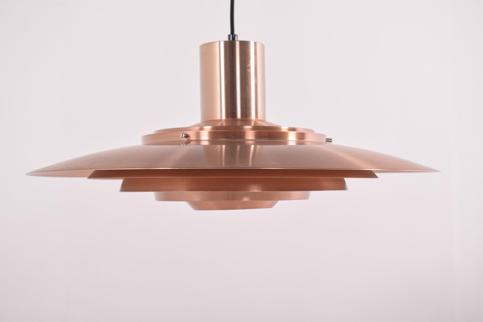 Copper ceiling lamp by Preben Fabricius & Jørgen Kastholm for Nordisk Solar, 1950s. Majestic floating from the ceiling is the result of this elegant copper ceiling light. Made from the best materials and built quality. This iconic design will