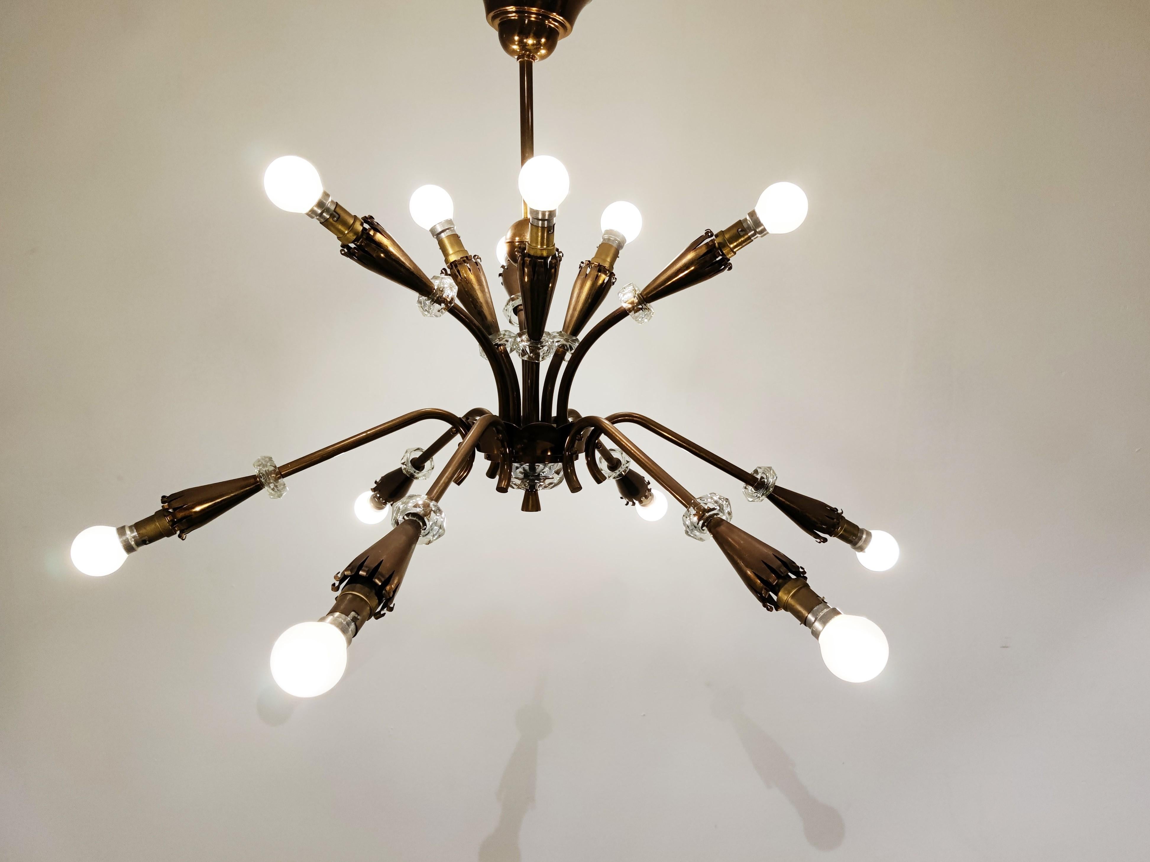 Elegant copper spider or sputnik chandelier with cut glass details.

The light shades have a 'curled' finish and the chandelier has the right patina. 

1950s - France

Works with bayonet lamps.

Tested and ready to use

The chandelier has