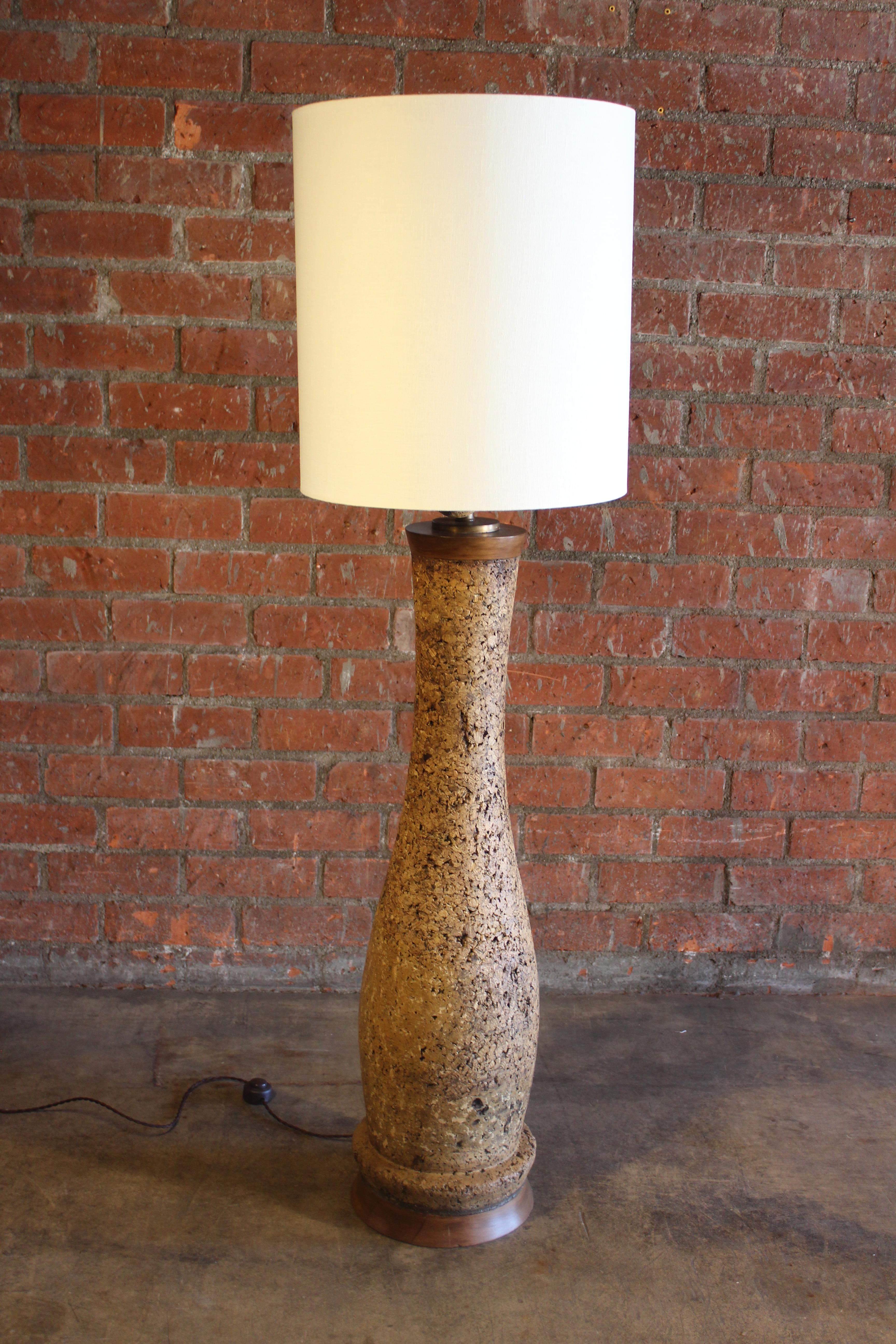 A vintage monumental cork floor lamp with a wooden base and linen shade, from the 1960s. Newly refinished and newly rewired, complete with a custom made linen shade.