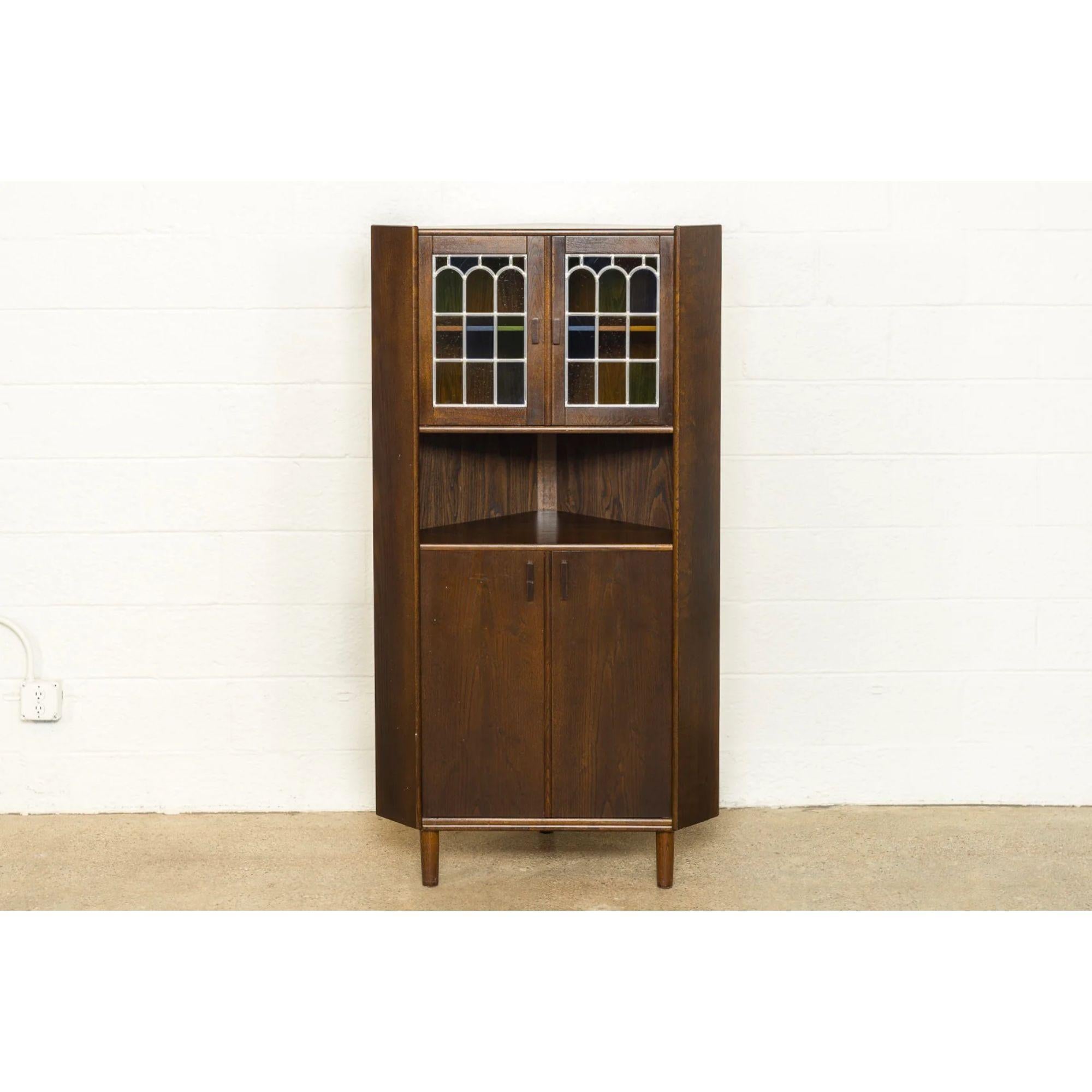 Vintage Mid Century Danish Modern Teak Stained Glass Corner China Cabinet

This vintage mid century Danish modern teak with stained glass corner cabinet is circa 1960. The classic Scandinavian modern design has clean minimalist lines. This unique