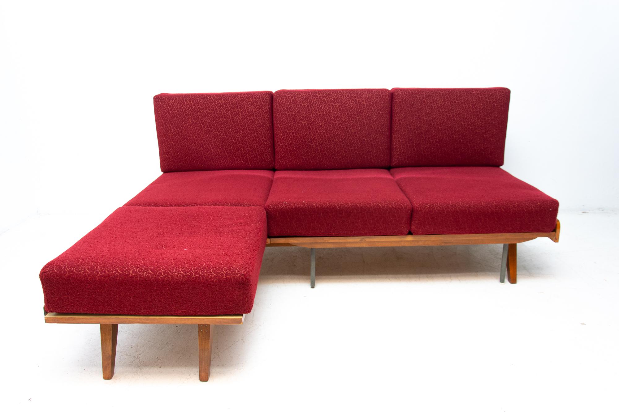 Midcentury corner folding sofa designed by František Jirák for Tatra nábytok. It was made in the former Czechoslovakia in the 1960s. This sofa features a wooden structure that is veneered in walnut. The sofa is in very good vintage condition. Only