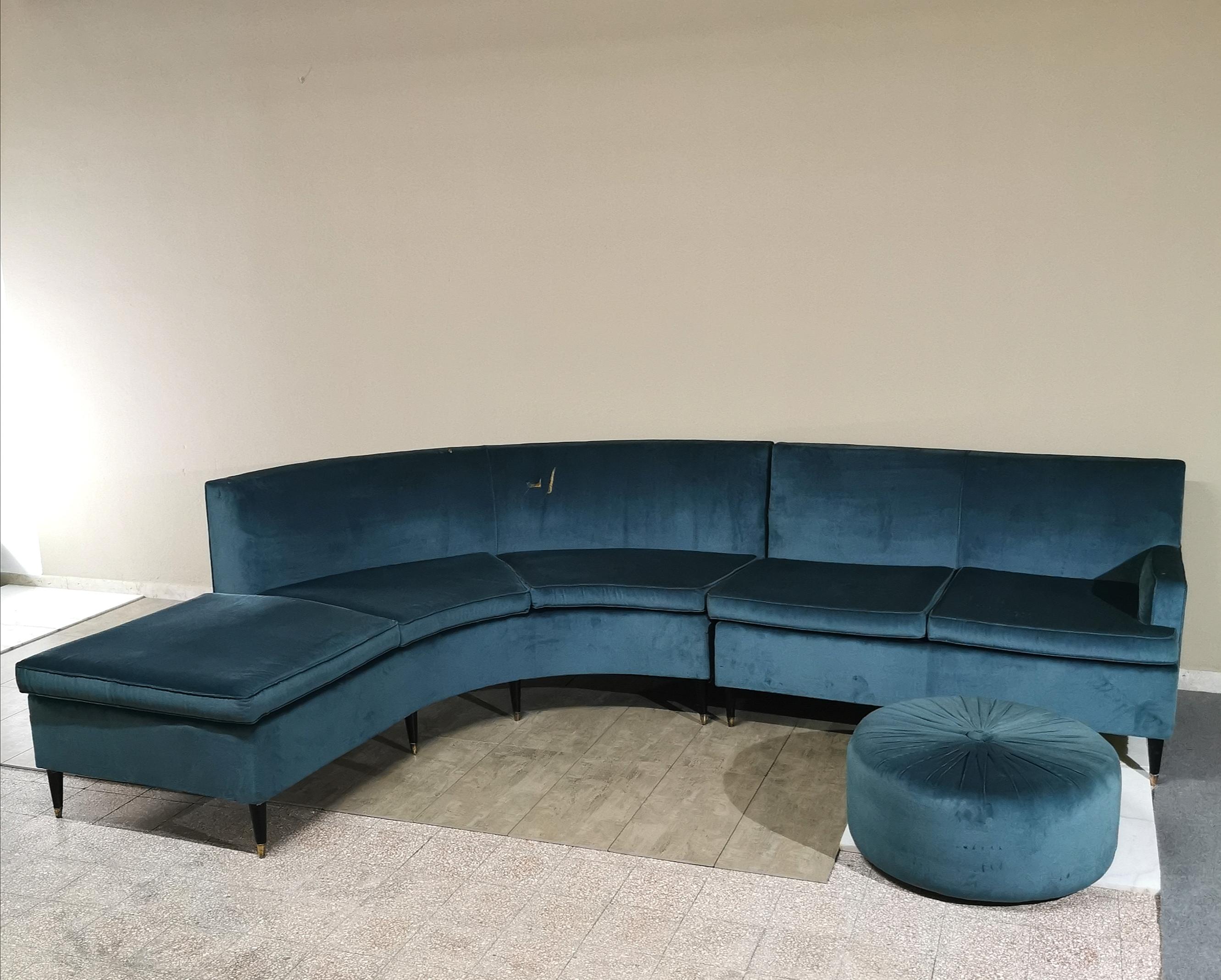 Elegantes Ecksofa in glattem türkisfarbenem Samt, bestehend aus zwei Elementen, einem geschwungenen und einem zweisitzigen mit konischen Holzfüßen und Messingschalen. Das Set wird durch einen großen runden Hocker ergänzt. Italienische Produktion aus