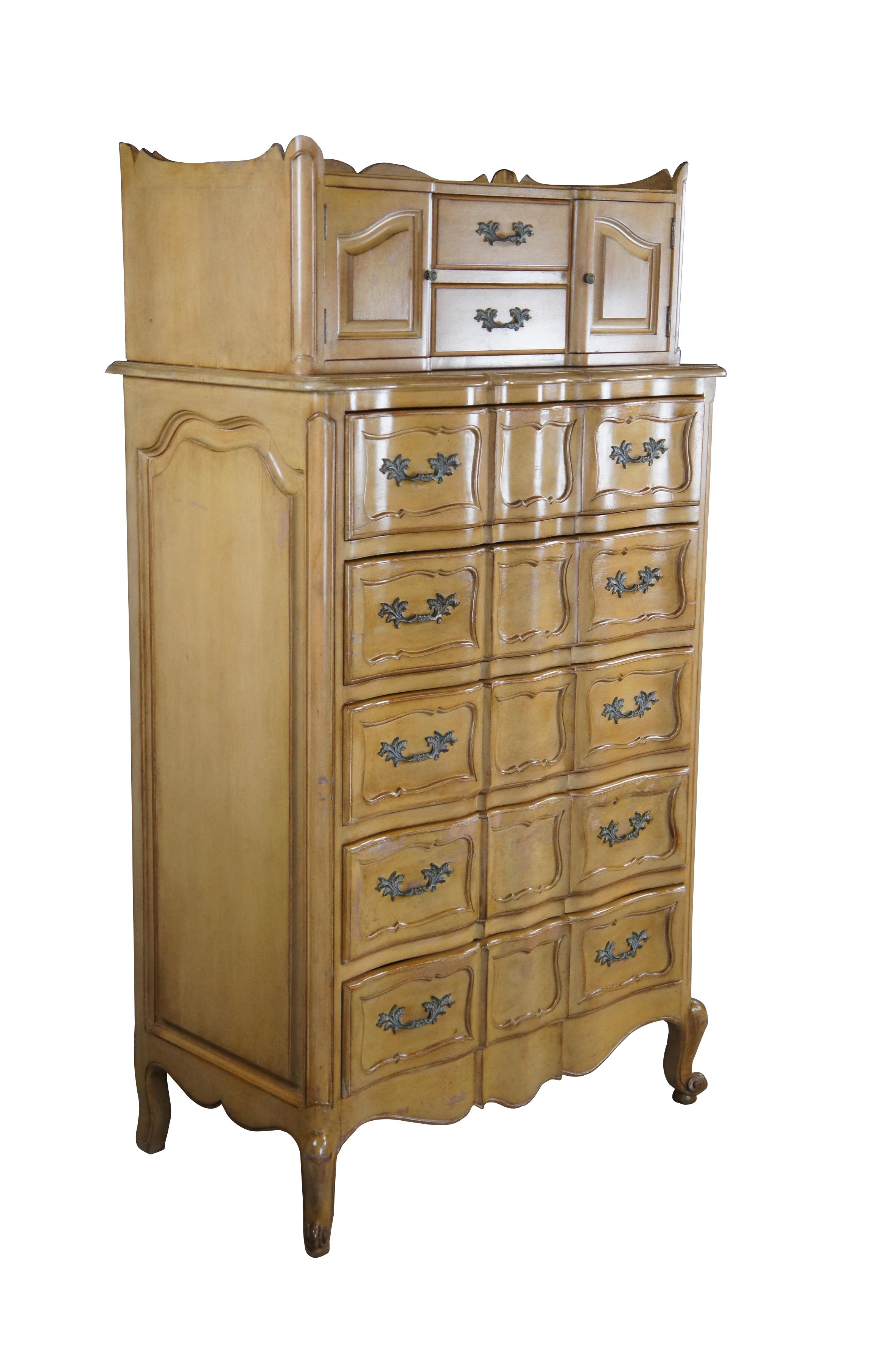 Mid century French Provincial highboy / tallboy chest on chest dresser featuring serpentine form with seven drawers and two cabinets with upper gallery and cabriole legs.  Attributed to Bethlehem Furniture Co.


Dimensions:
21