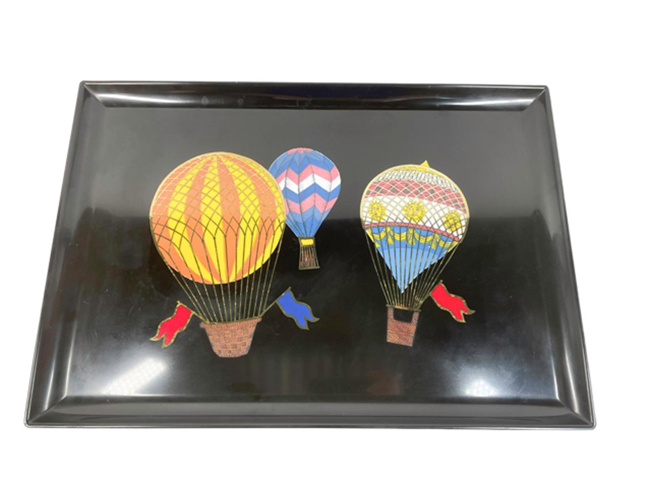 Mid-Century Modern serving tray made of black phenolic resin and inlaid with bright colored resins and brass hot air balloons. Phenolic resin was used for its resistance to damage from alcohol, hot water and cigarettes. 