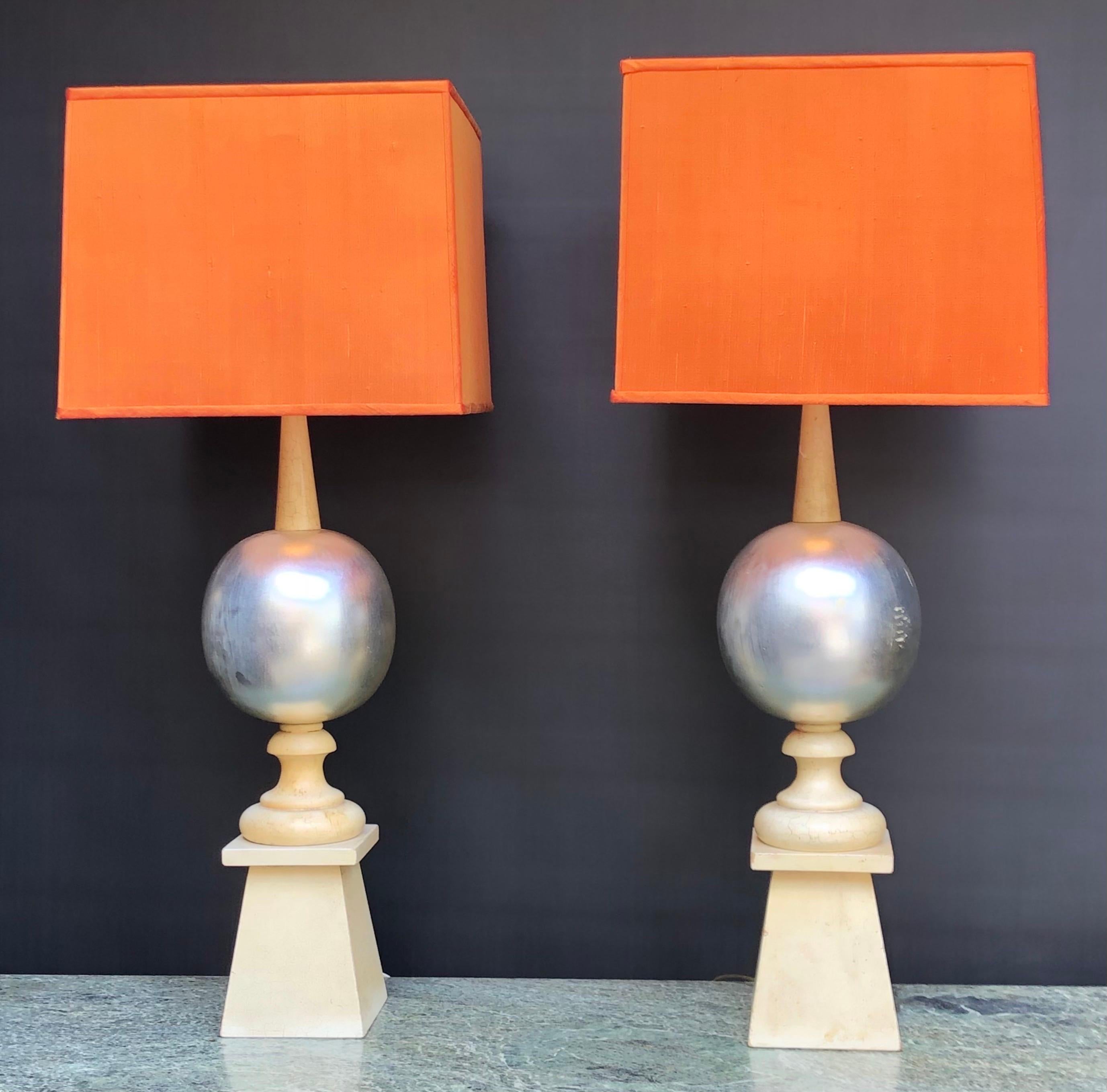 An elegant pair of Mid-Century Hollywood Regence Cream Lacquered & Silver Leafed Wood Spire Lamps By James Mont.  The Regal James Mont Lamps have Exotic Caribbean Coral Color square lampshade resting on the original Milk-glass reverse cone Light