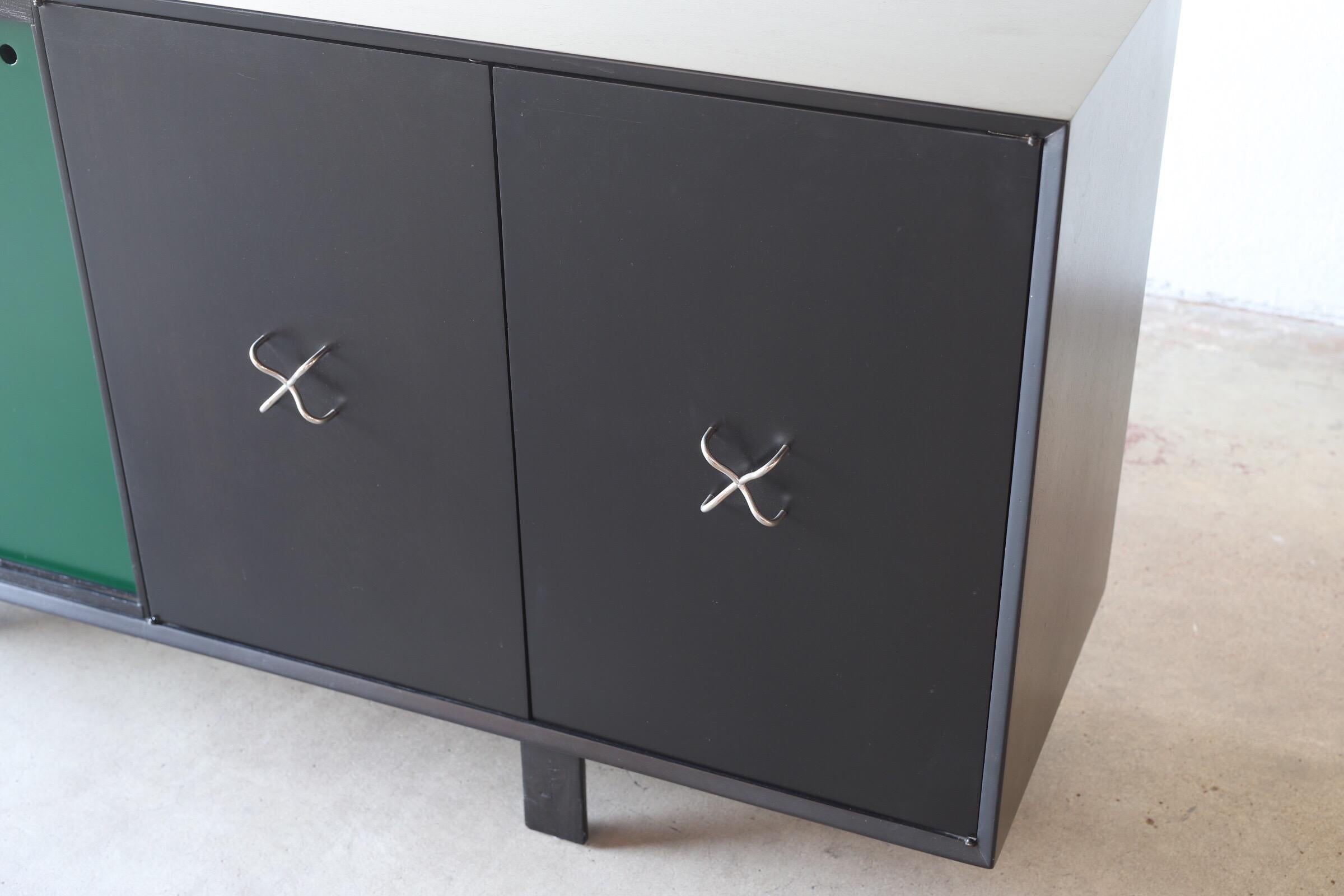 Ebonized buffet or credenza with double doors and green sliding doors. Piece is completely refinished with freshly polished hardware. Three adjustable shelves total, for easy organization.