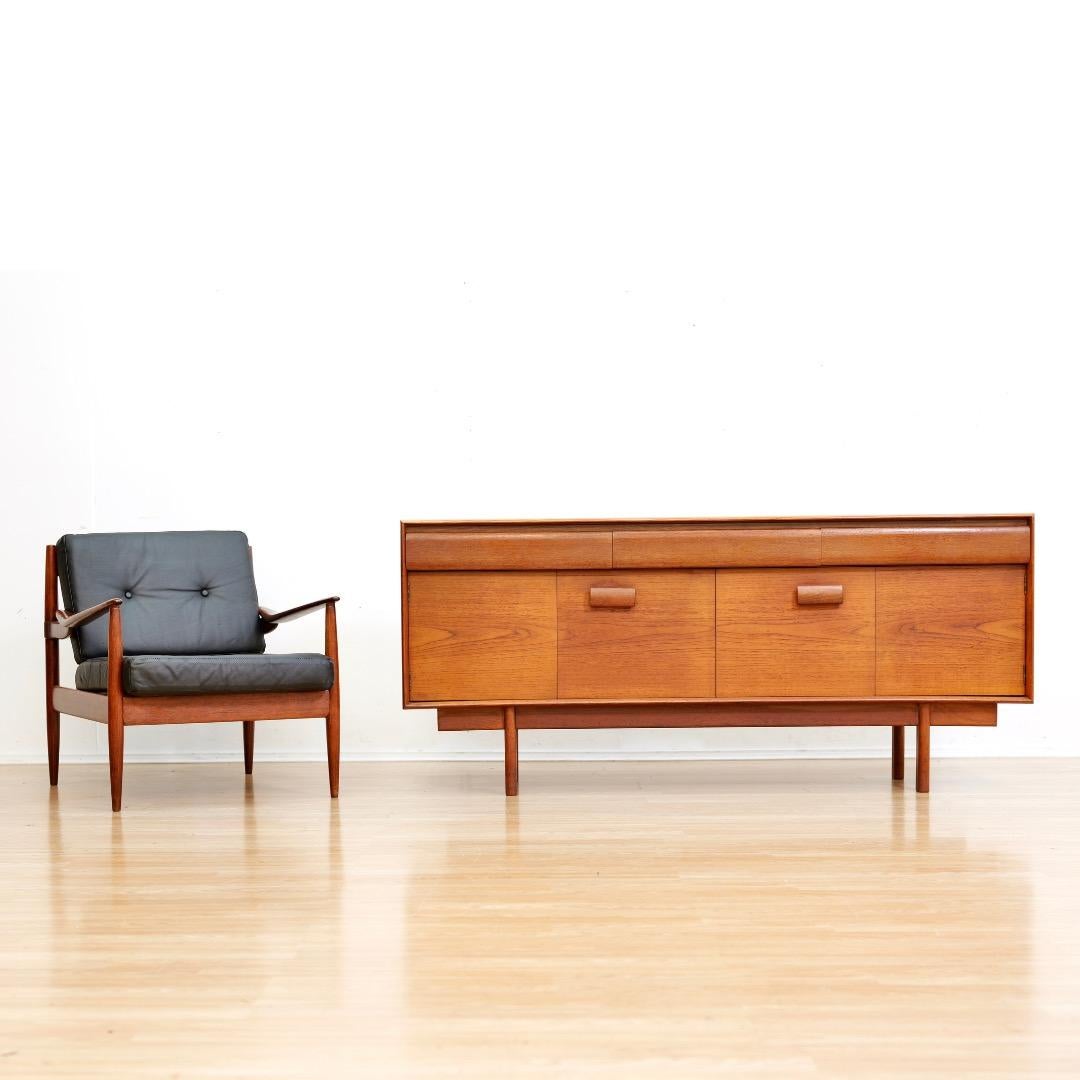 This superb ‘Winchester’ teak credenza was designed by Philip Hussey for White 
Newton of Portsmouth, 1960s.  Features a pair of concertina doors opening to a spacious interior with a fixed full-length shelf, above there are three drawers,