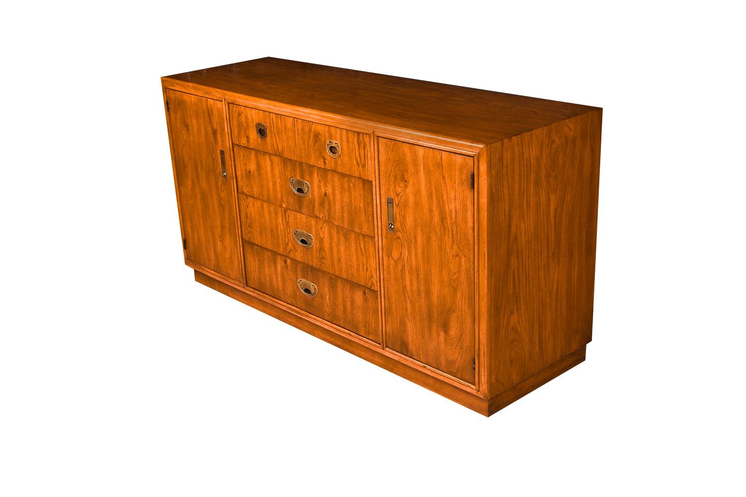 A gorgeous, Boho Drexel Campaign mid-century, credenza, dresser.  Minimalist Danish Modern inspired profile, with exceptional construction and style and adorned with original stylish, sculpted, brass pulls. Two   available. Features rectangular top