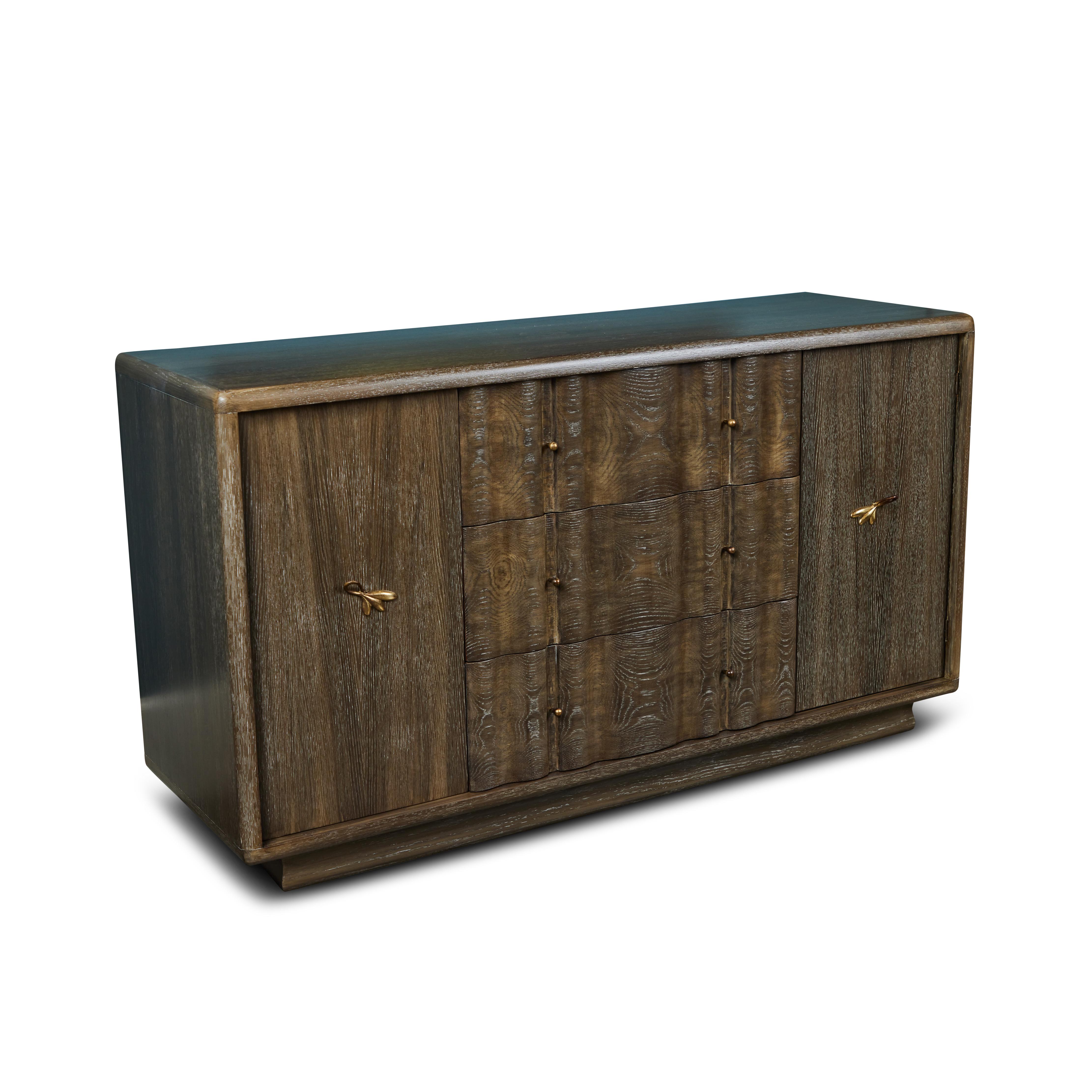 This fantastic mid century credenza has been refurbished with a beautiful rich new cerused oak finish. It has it's original decorative brass hardware, 3 center drawers and 2 cabinets and is the perfect piece for all your storage needs.

 