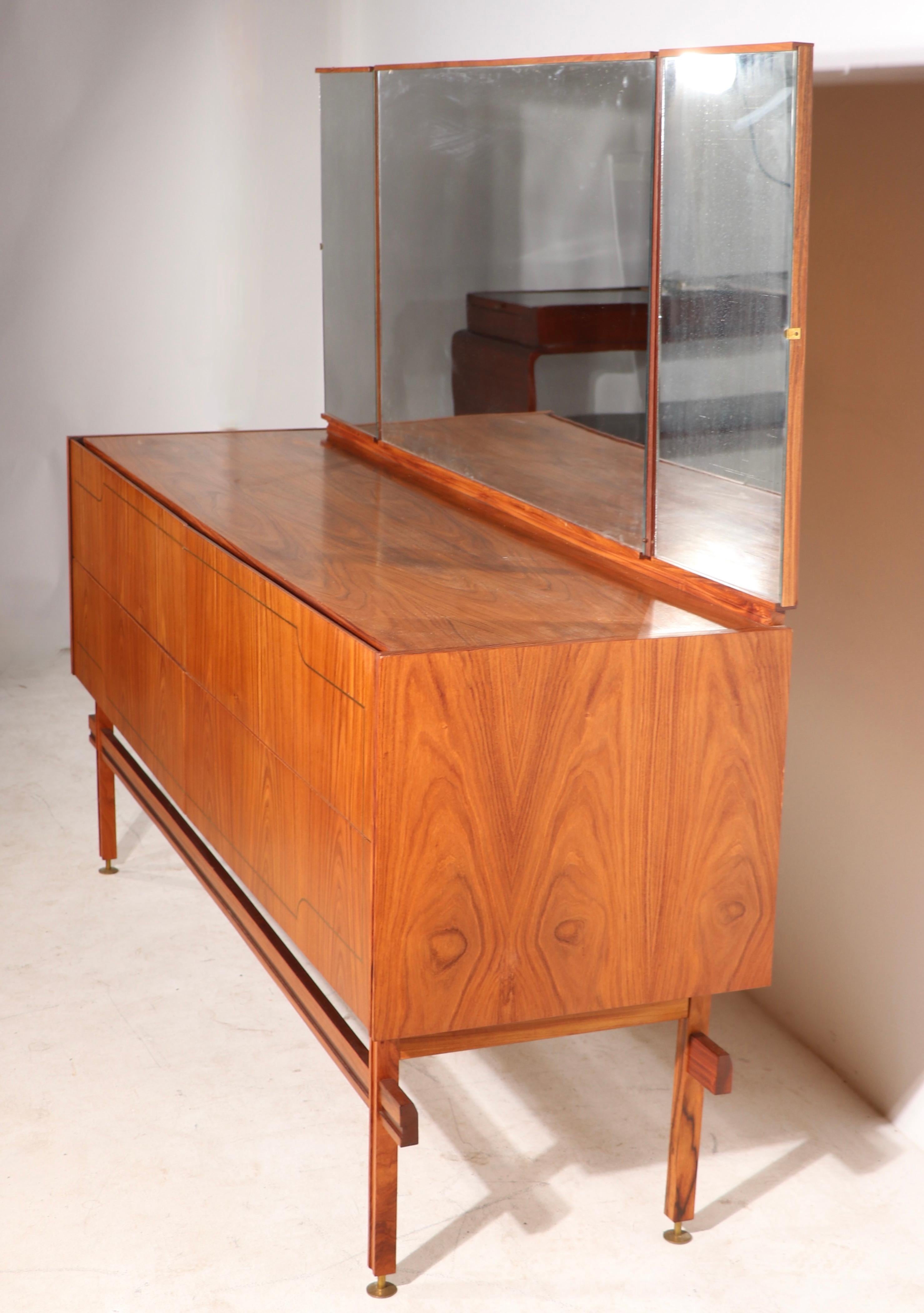 Spectacular Mid Century credenza, made in Brazil - designed by Carlo Hauner and Martin Eisler.
 This example is in very good, original condition, clean and ready to use. The case has vibrant Jakarta veneer, with pencil brass trim. The lower case