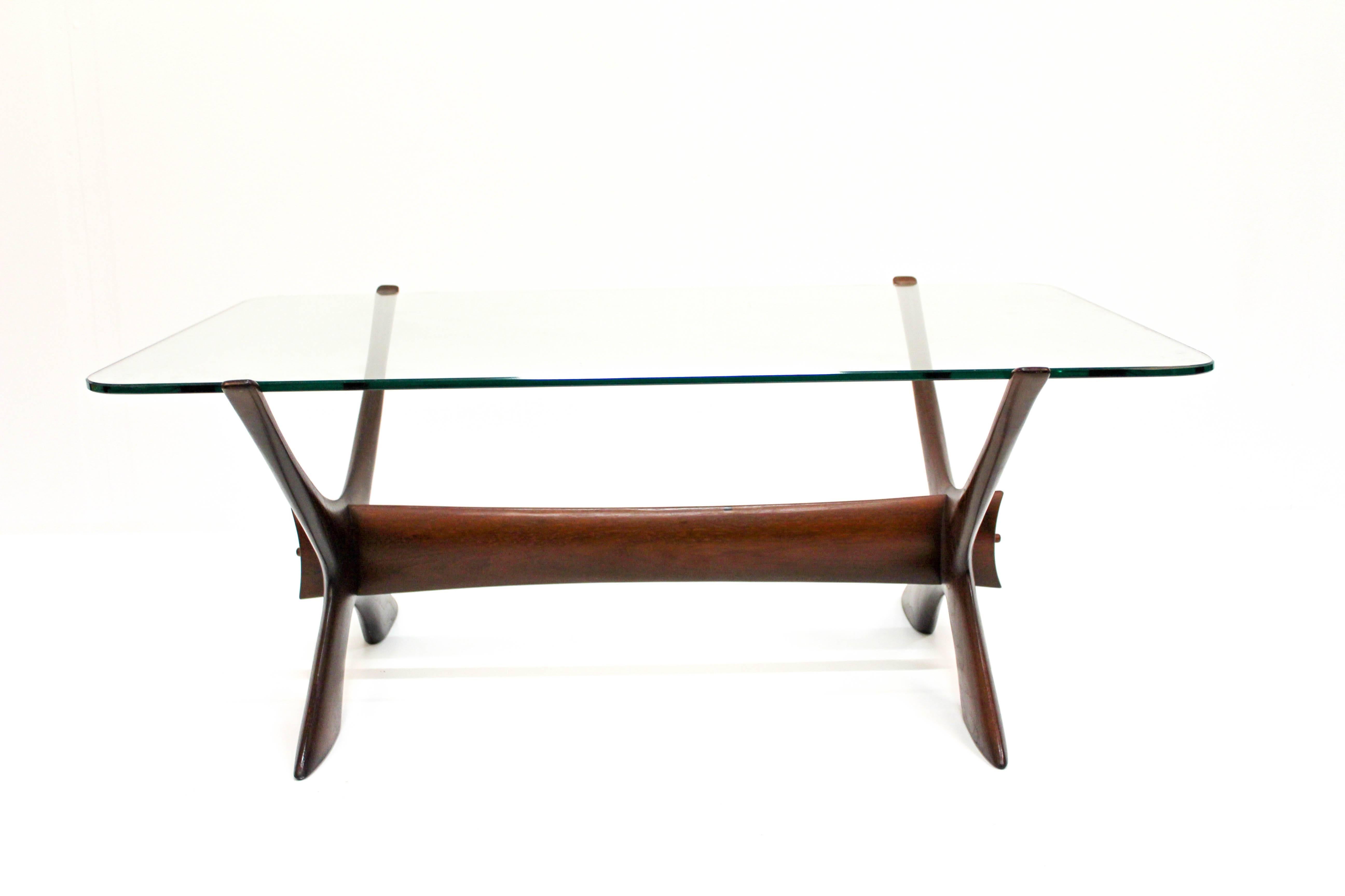 Midcentury Swedish coffee table designed by Fredrik Schriever-Abeln. The table has a beautifully sculptured teak frame and a tabletop made out of glass with rounded edges. The table is in good vintage condition with signs of usage, especially where