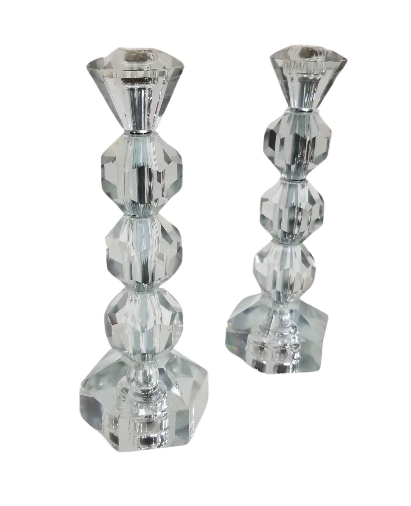 Elevate your decor with this exquisite pair of Mid Century Modern candlesticks featuring cut glass with a distinctive diamond-shaped top. These timeless pieces seamlessly blend vintage charm with modern sophistication, adding a touch of elegance to