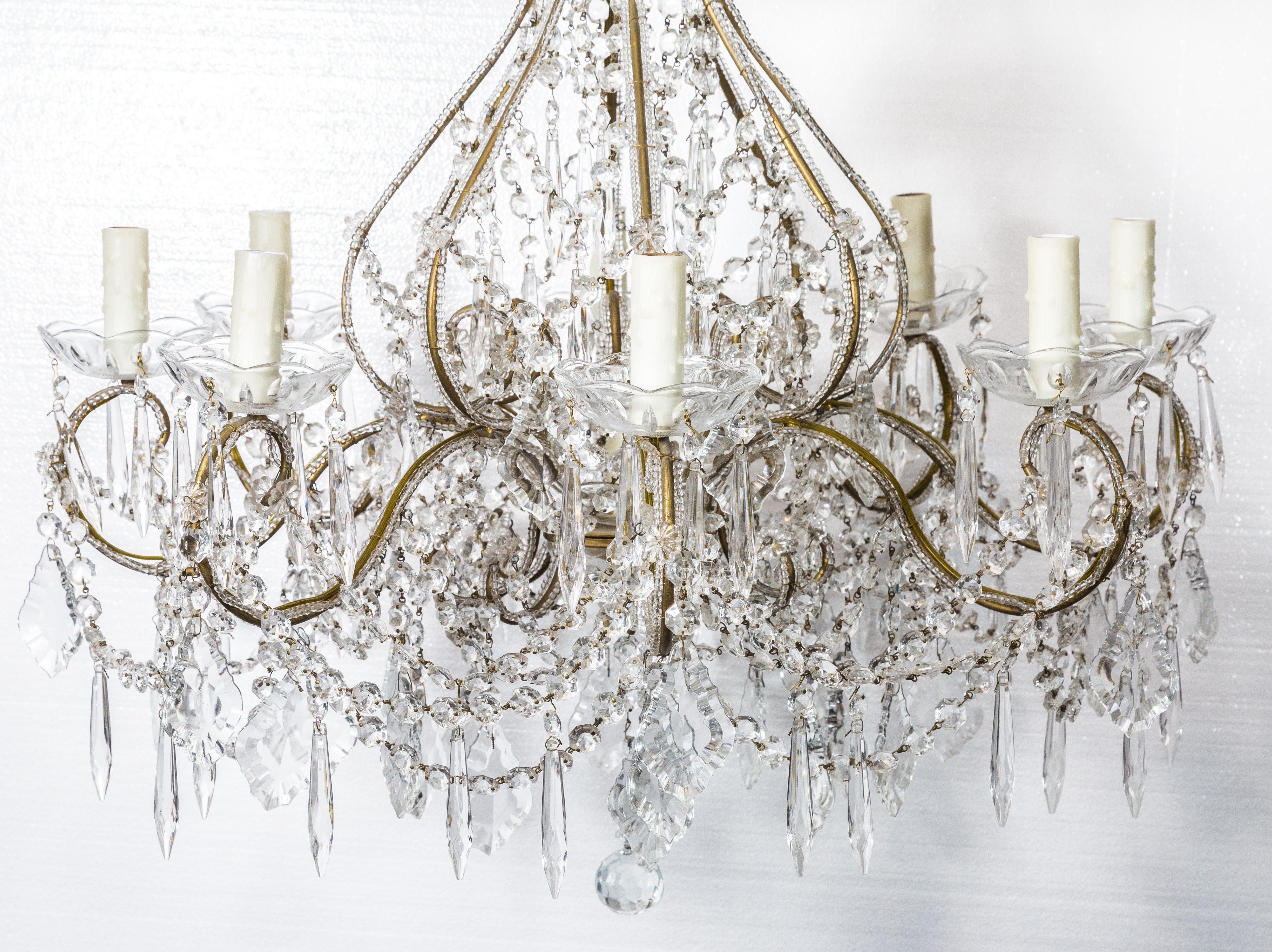 Midcentury crystal chandelier, with a gold frame, amazing for a dinning room.