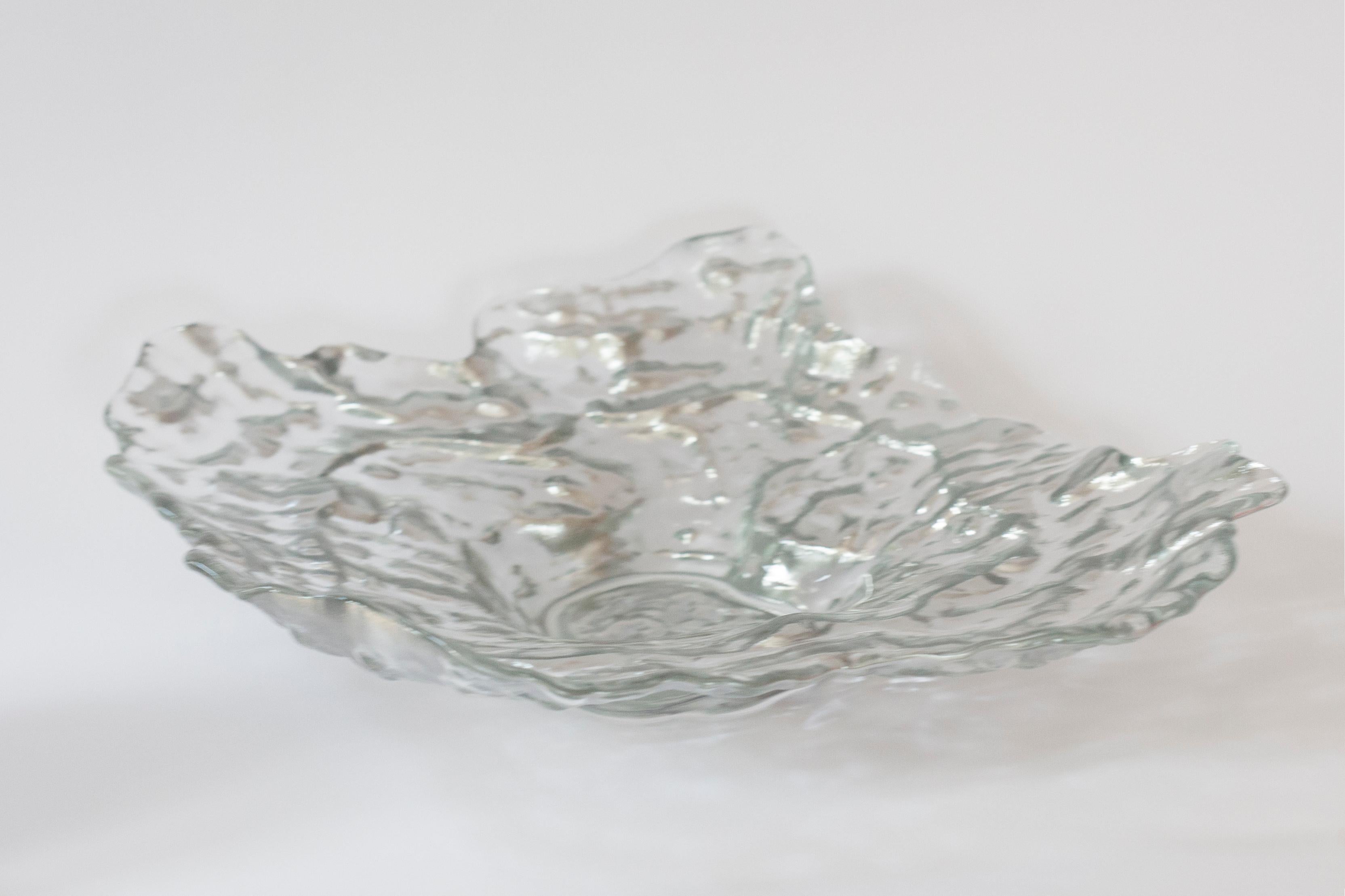This original vintage glass element was designed and produced in the 1970s in Lombardia, Italy. It is made in Sommerso Technique and has a fantastic faceted form. The vibrant silver color makes this items highly decorative. This item is a high
