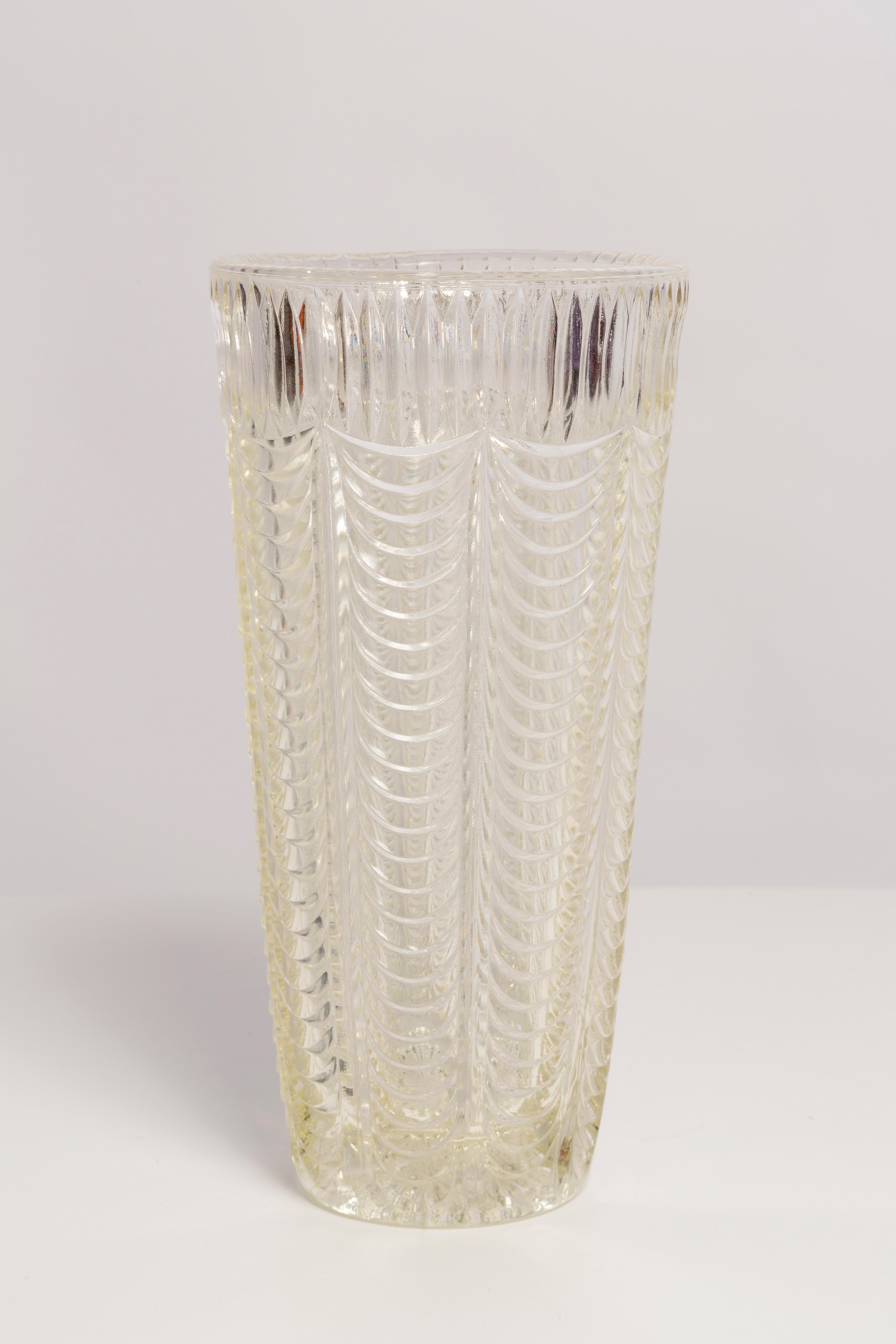 Transparent vase in amazing shape. Produced in 1960s.
Glass in perfect condition. The vase looks like it has just been taken out of the box.

No jags, defects etc. The outer relief surface, the inner smooth. 
Thick glass vase, massive.

The