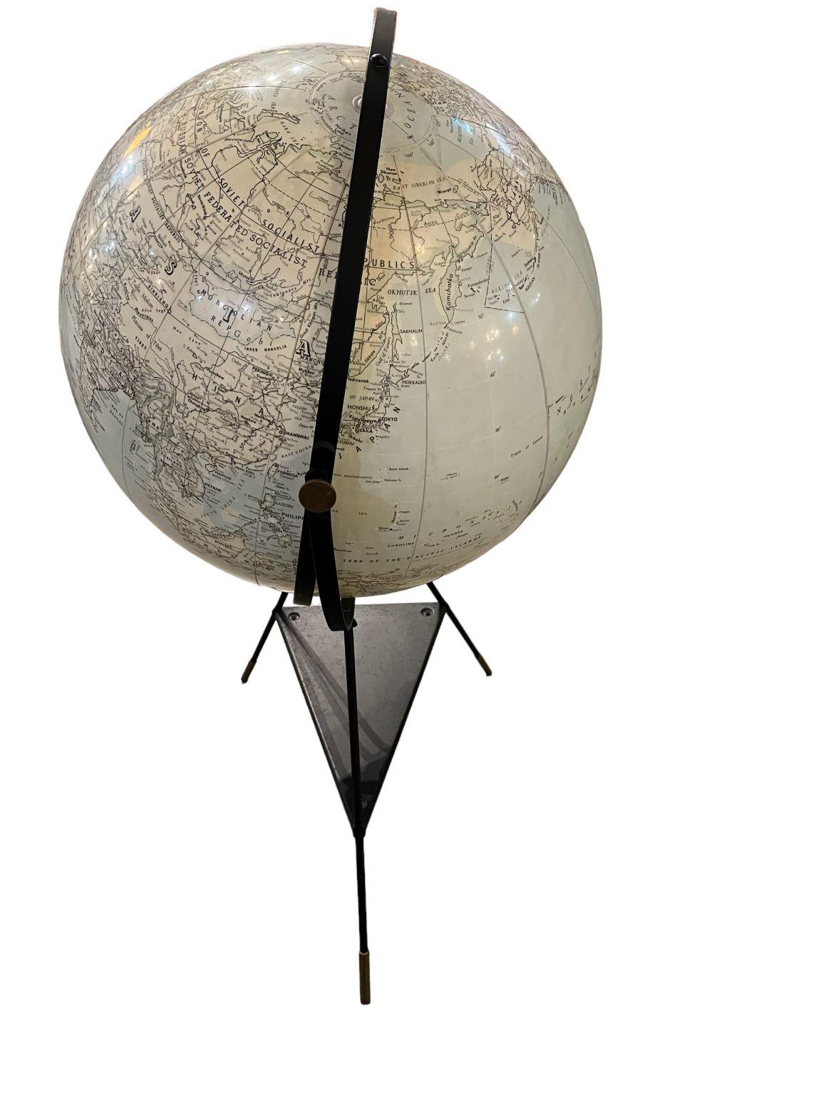 Hammond's International Globe circa 1955 composed of an inflatable globe on painted metal tripod base. Durable as a beach ball, this vinyl globe is inflatable / deflatable by way of a locking port mechanism located at the top of the globe.