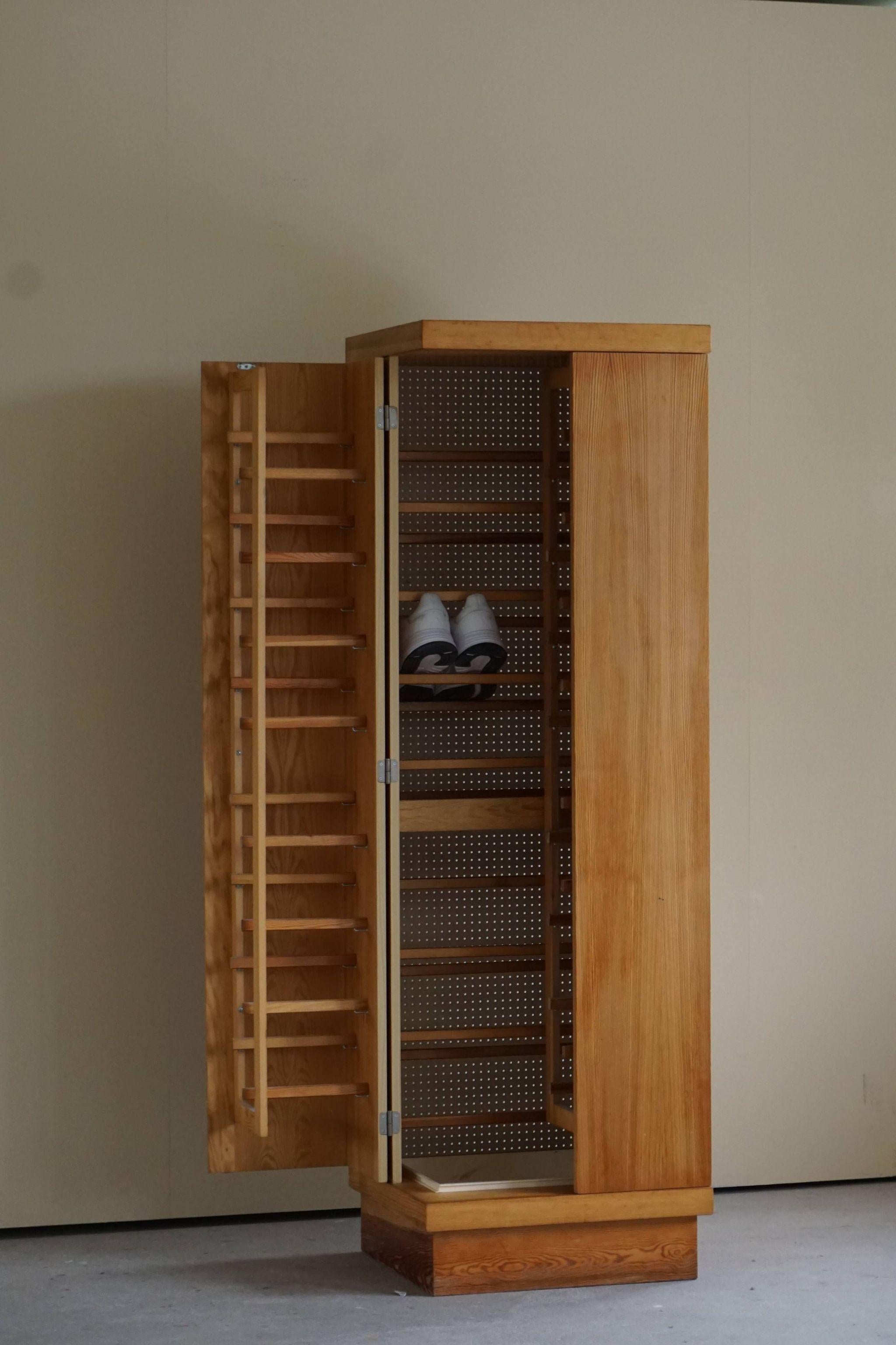 Unique mid century cubist shoe cabinet in pine, made by a Danish cabinetmaker, ca 1980s. 

Such a sculptural piece with great patina, ideal for your shoe collection. 

A great decorativ object for the modern interior. A warm colour and patina that