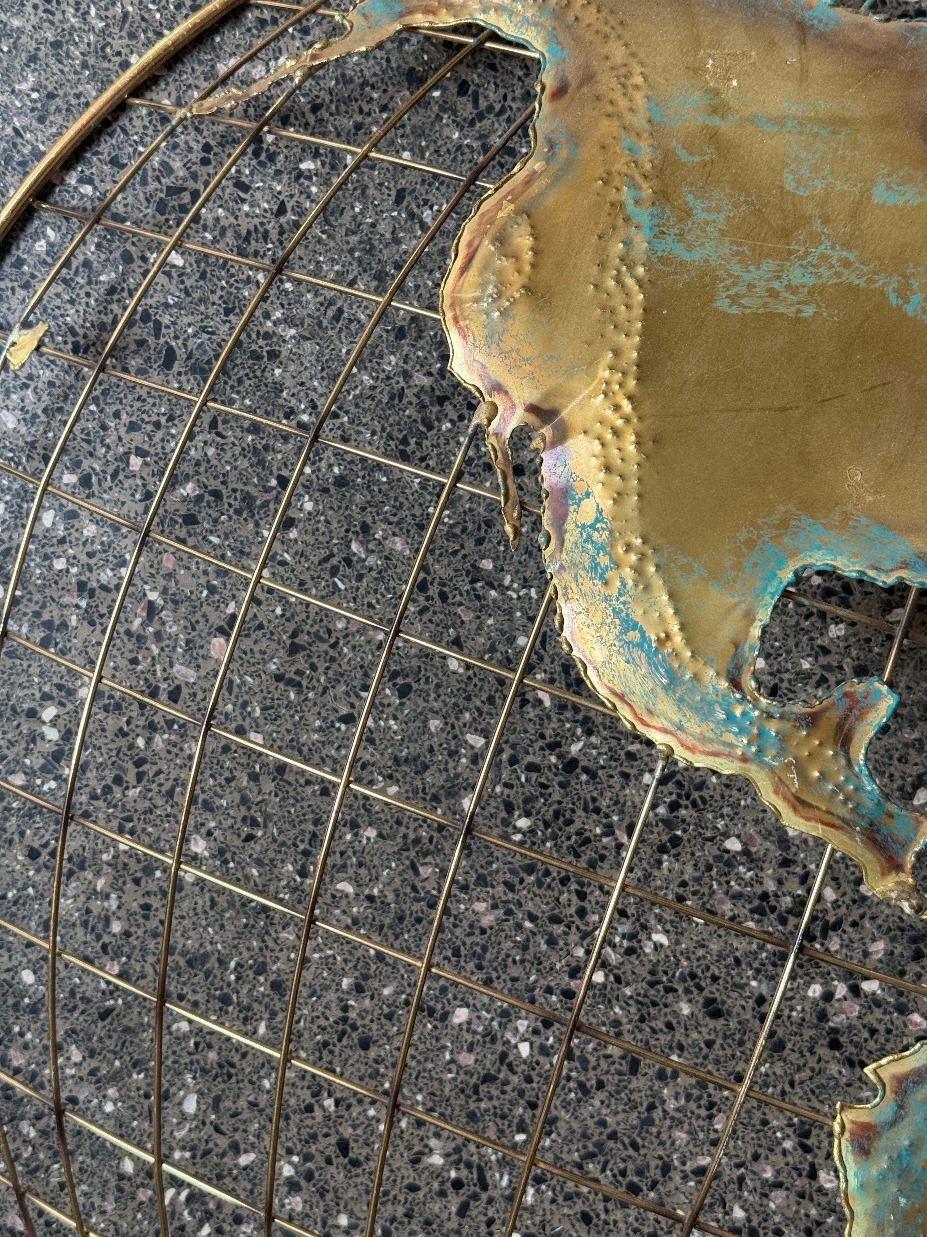 Mid-century brass wall sculpture art. By Curtis Jere, signed 1982, and sold as a pair. Depicting a map / globe. A great pair for an office with perfect patina. In overall good vintage condition with minor wear consistent with age and use. Signed and