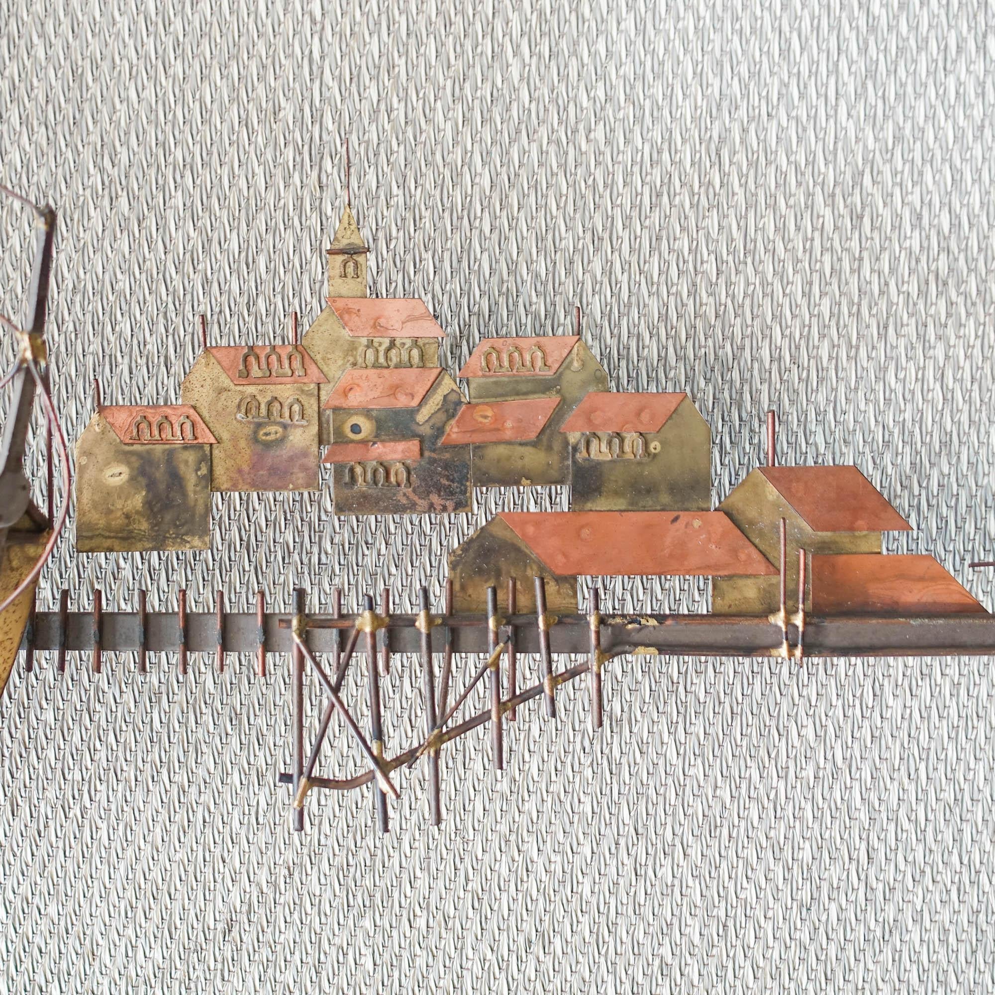 This wall sculpture was designed by Curtis Jere and produced for Artisan House, in USA, during the 1970's. It is made of brass, iron and copper and represents a boat in village and it's port. Curtis Jeré was the shared pseudonym of two artists,