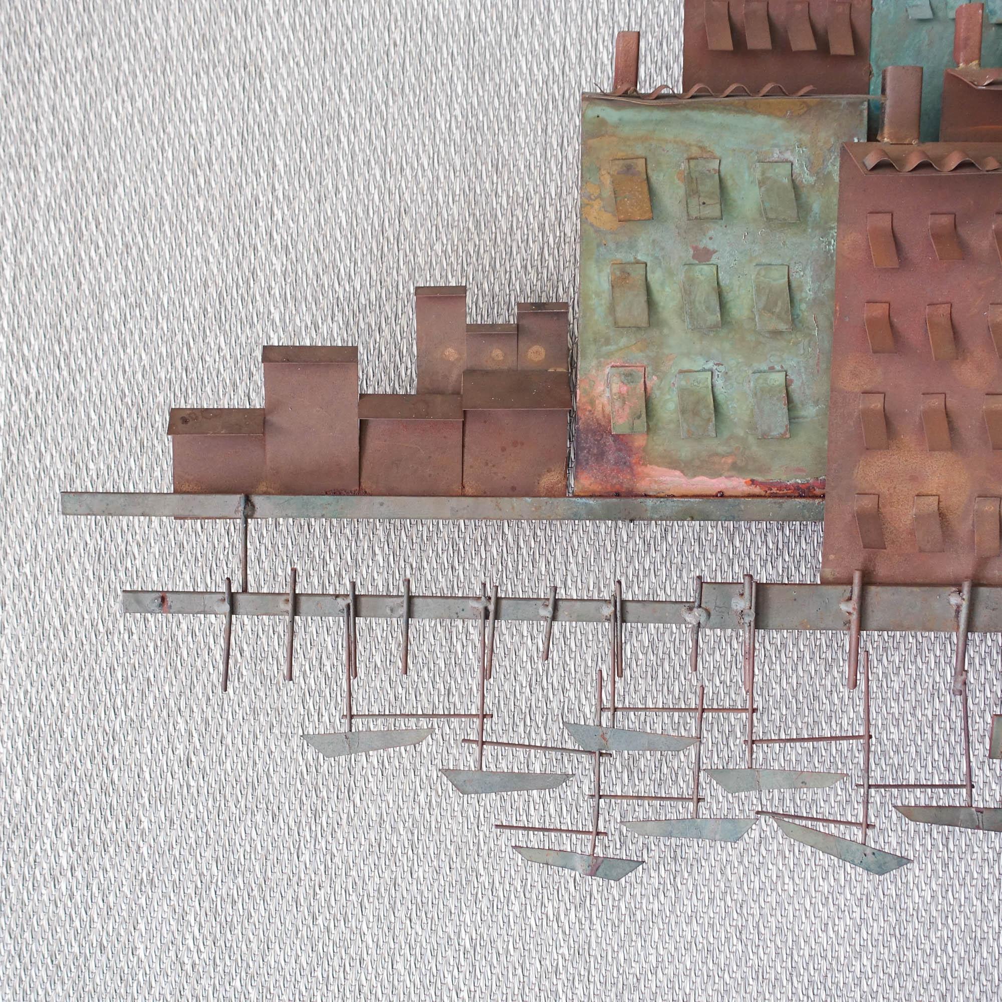 This wall sculpture was designed by Curtis Jere and produced for Artisan House, in USA, during the 1972s. It is made of brass, iron and copper and represents a village and it's port. Curtis Jeré was the shared pseudonym of two artists, Curtis