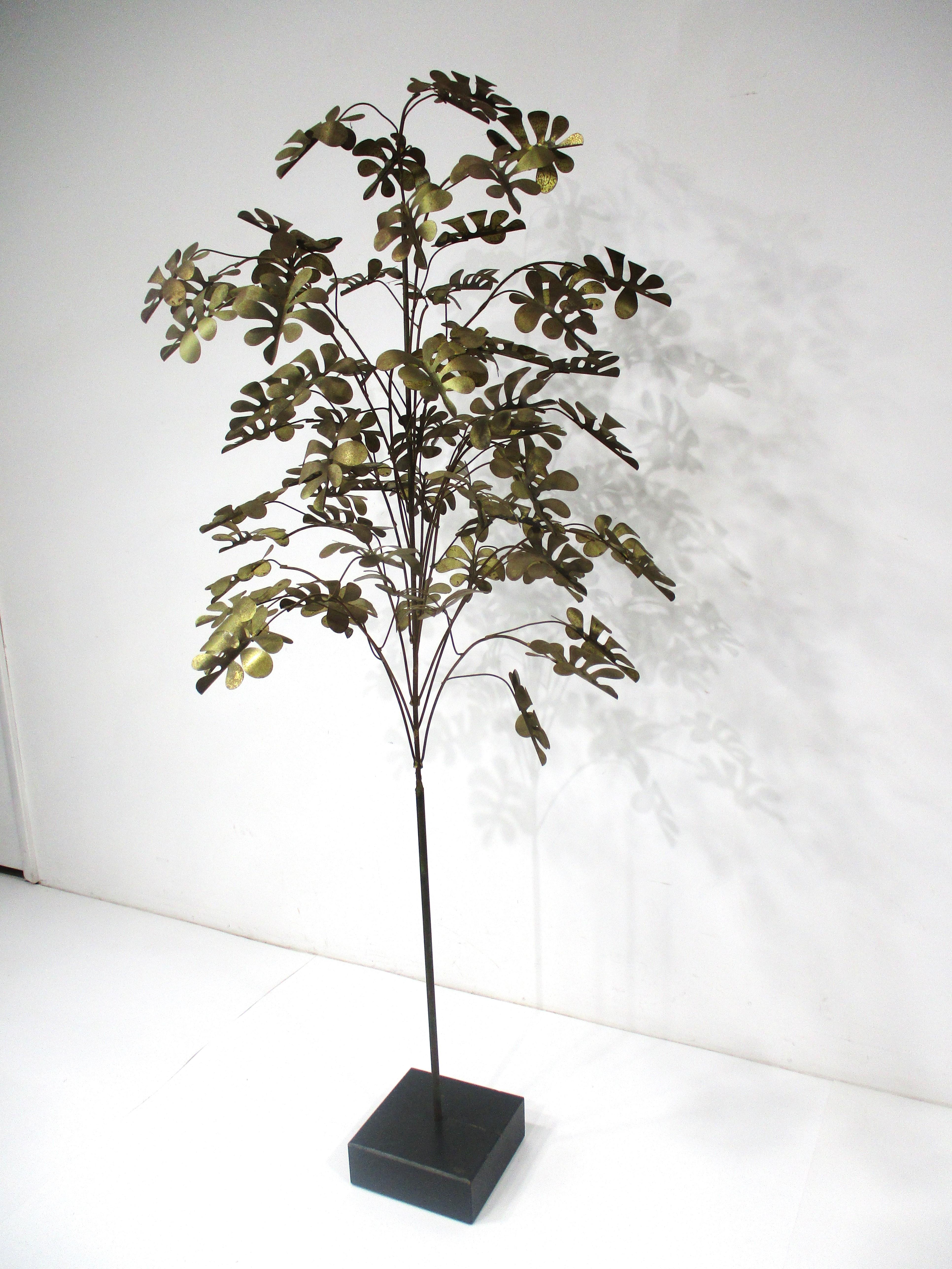 A very well crafted tree sculpture with mixed metal leaves , branches and trunk mounted on a block of ebony toned painted wood . By Curtis Jere known for their wall mounted and free standing metal creations , the piece  still retains the hand signed