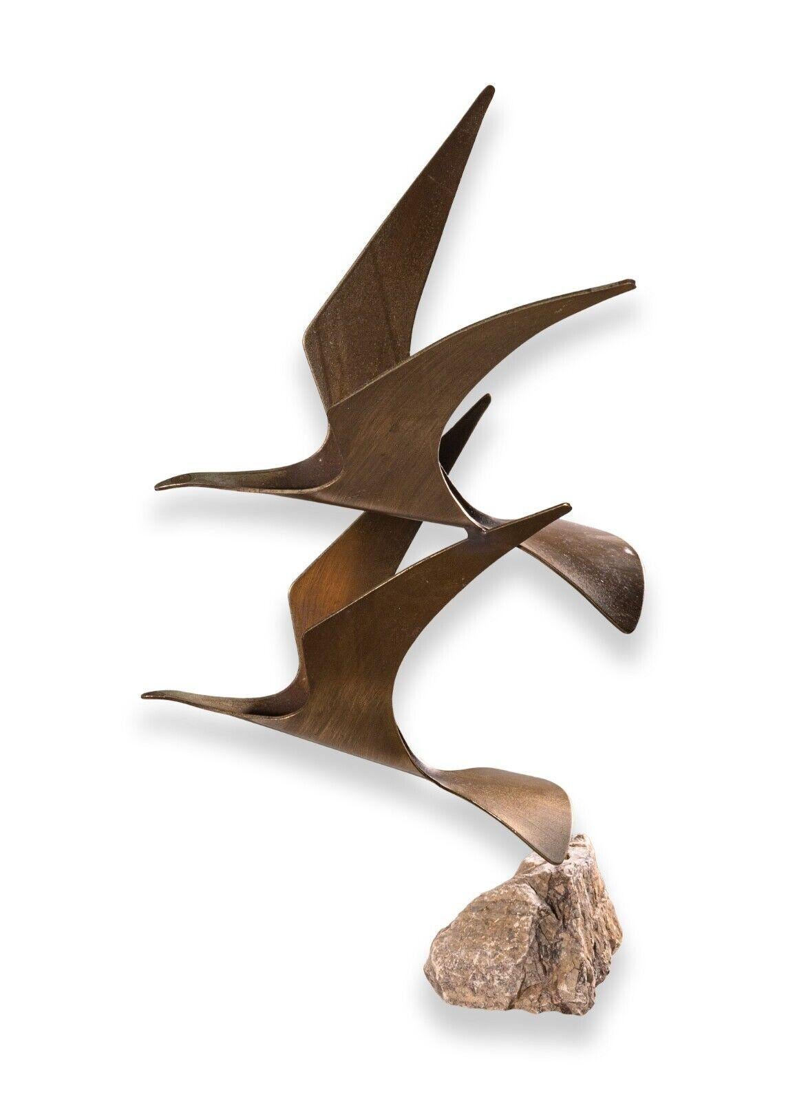 A Curtis Jere pair of doves bronze sculpture on quartz stone base. This is a stunning piece from the studio of Curtis Jere, signed and dated 1980 as pictured above. This piece features a pair of beautifully crafted bronze doves in flight, with a