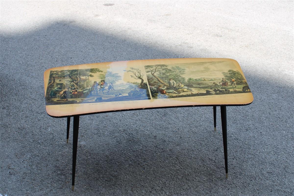 Midcentury curved coffee table with Wagner prints, metal feet and gold brass.