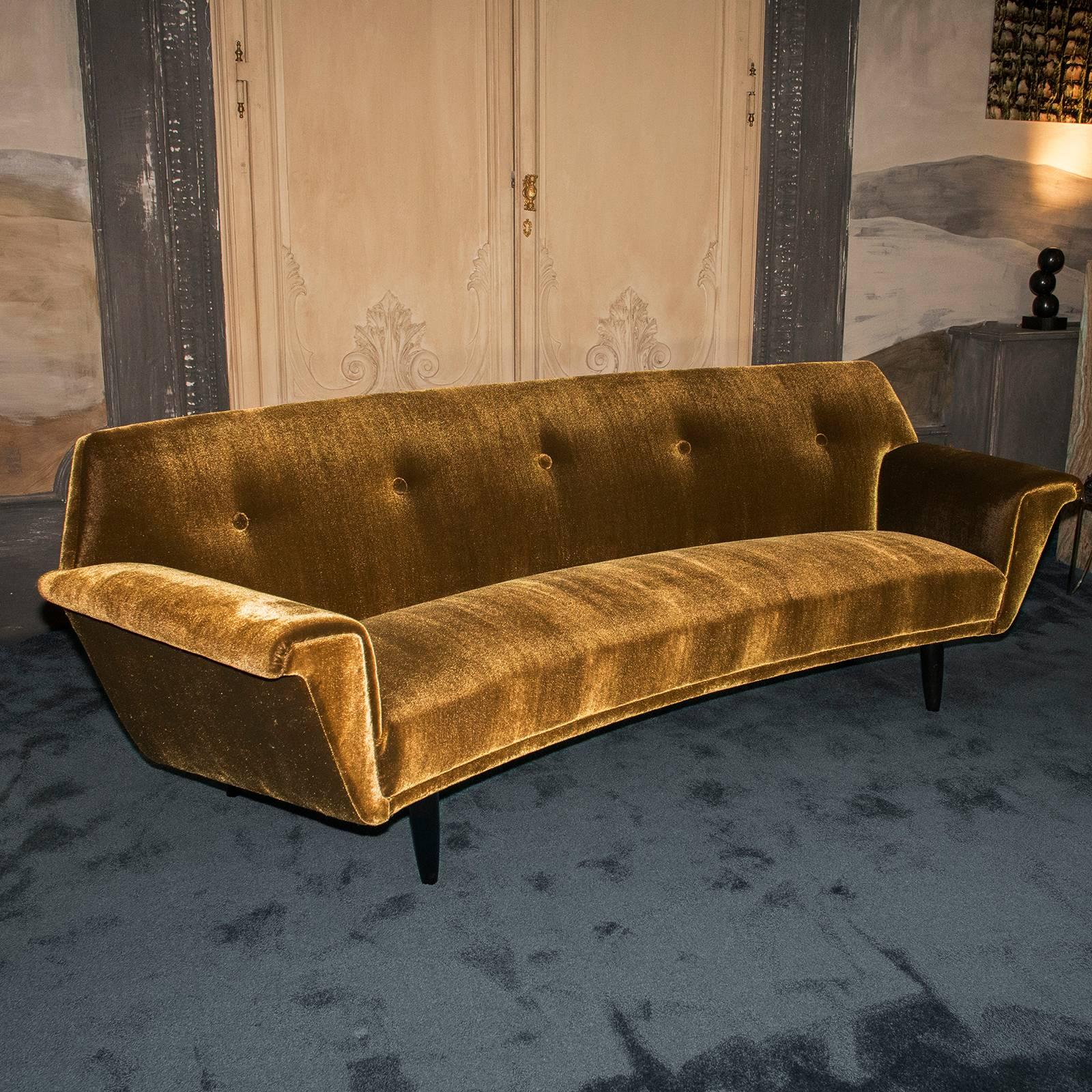 Italian curved sofa, vintage structure and newly reupholstered with dark gold velvet fabric, black wood details.
 