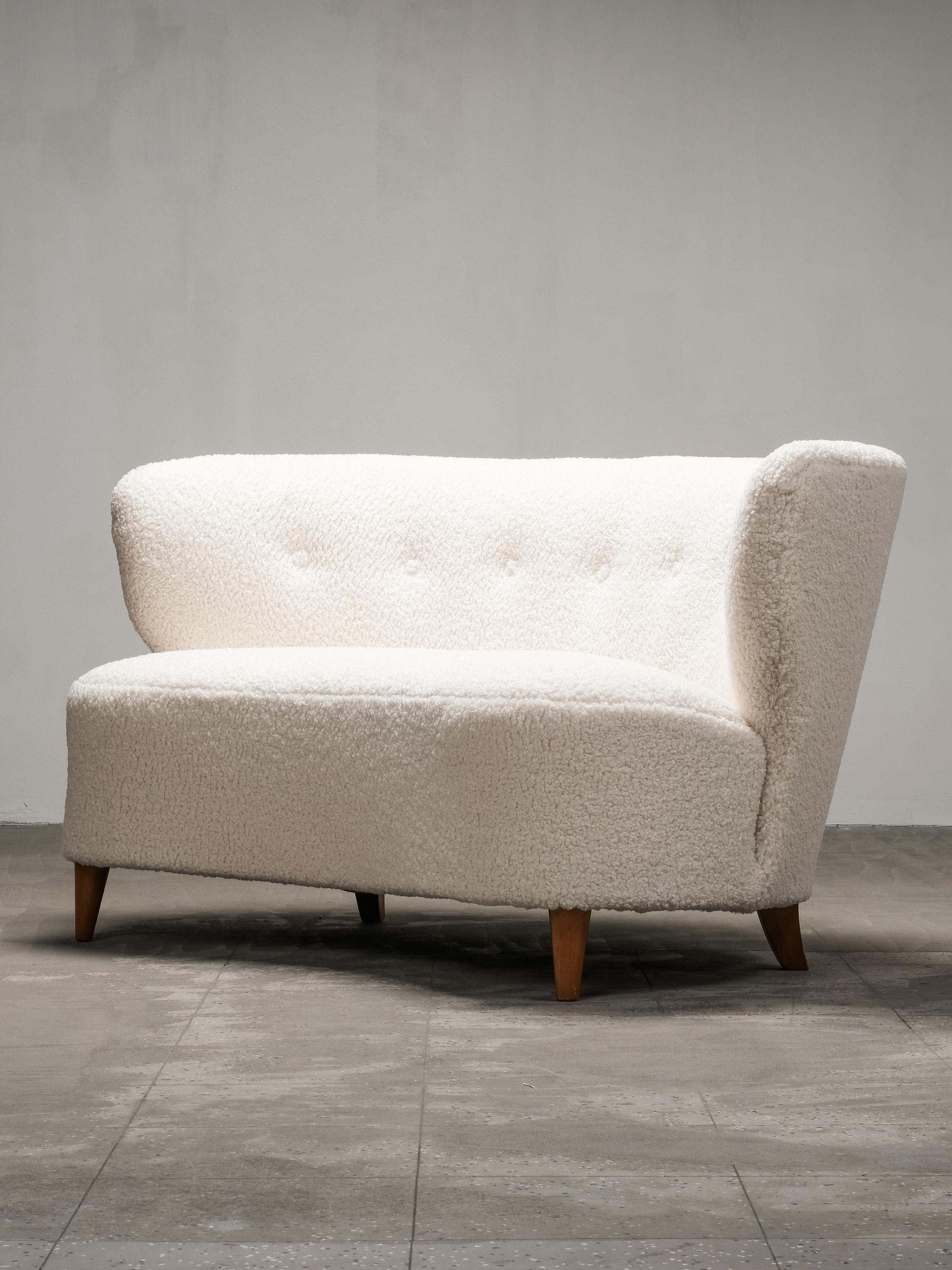 Ejemplo bellamente esculpido del primer modernismo escandinavo, este sofá curvo fue diseñado por Carl-Johan Boman para Boman Oy en Finlandia durante la década de 1940. Su forma suavemente ondulada y sus refinadas proporciones reflejan la tendencia