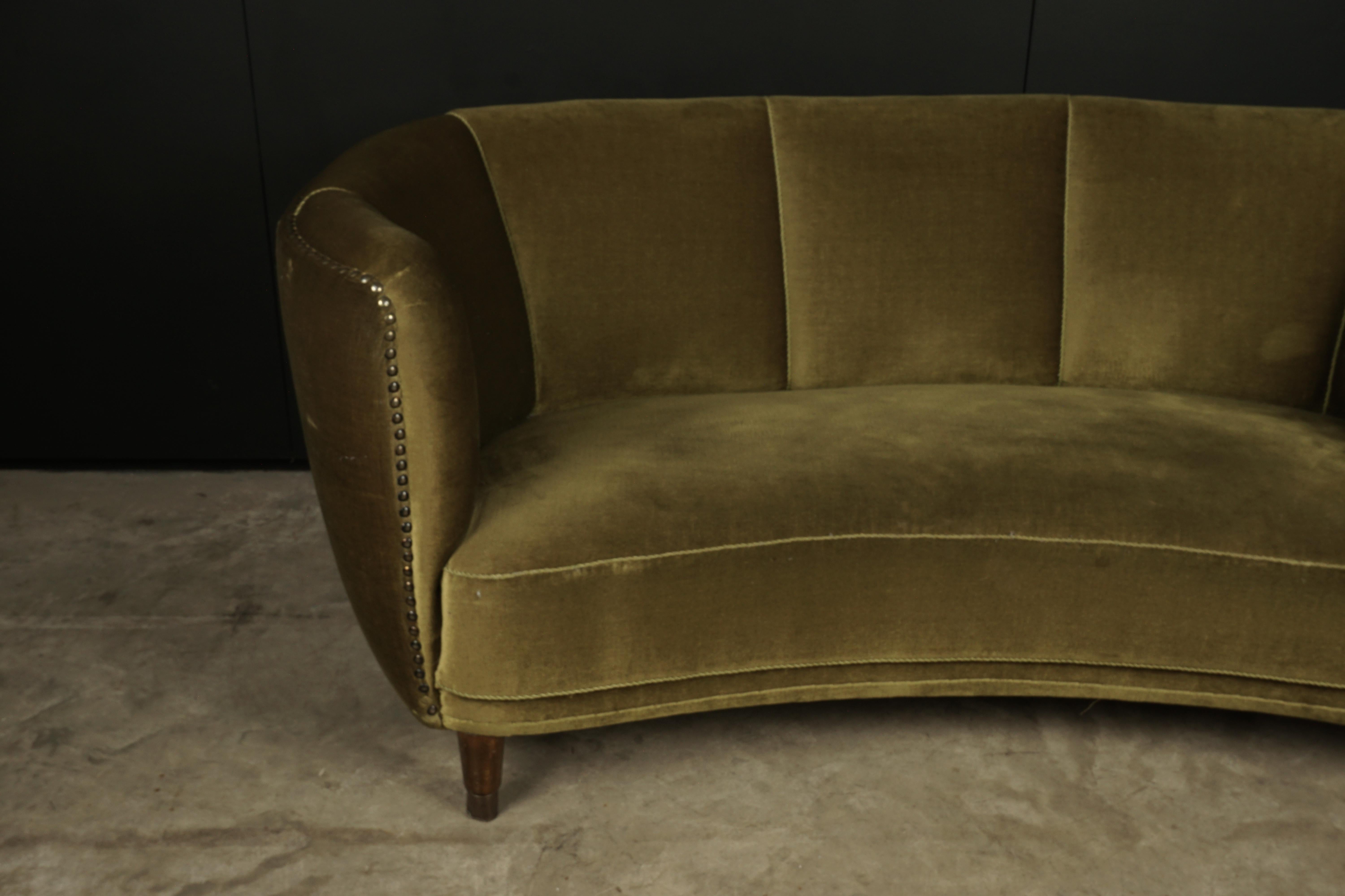 Midcentury curved velour sofa from Denmark, 1950s. Green velour upholstery with legs of stained beech.