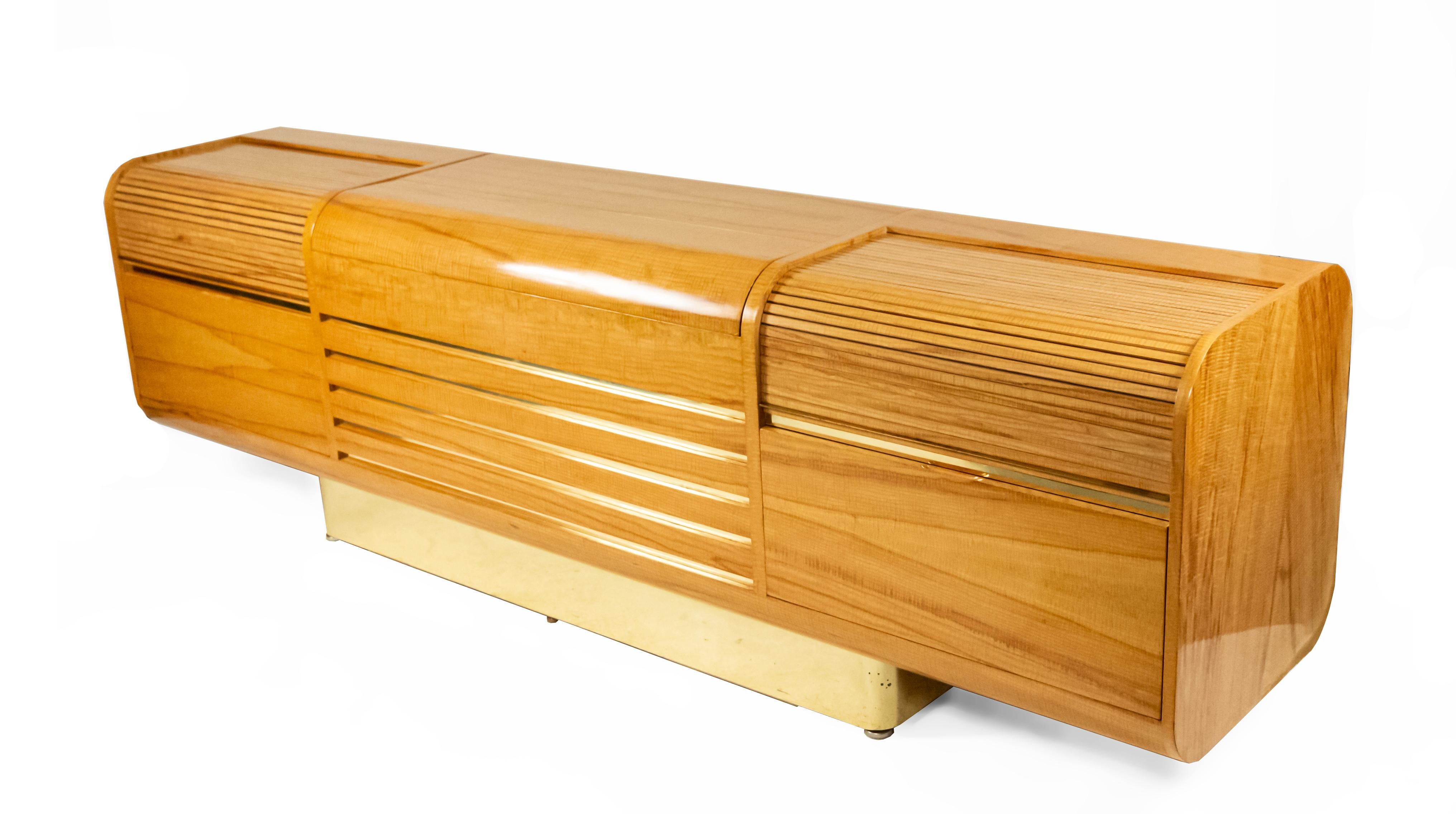 Midcentury tiger maple sideboard / bar with tambour side shelves over two drawers and center with raising mechanism and wine storage. This piece is a custom Vladimir Kagan design for JFK TWA Saarinen Terminal. Label on interior reads: 