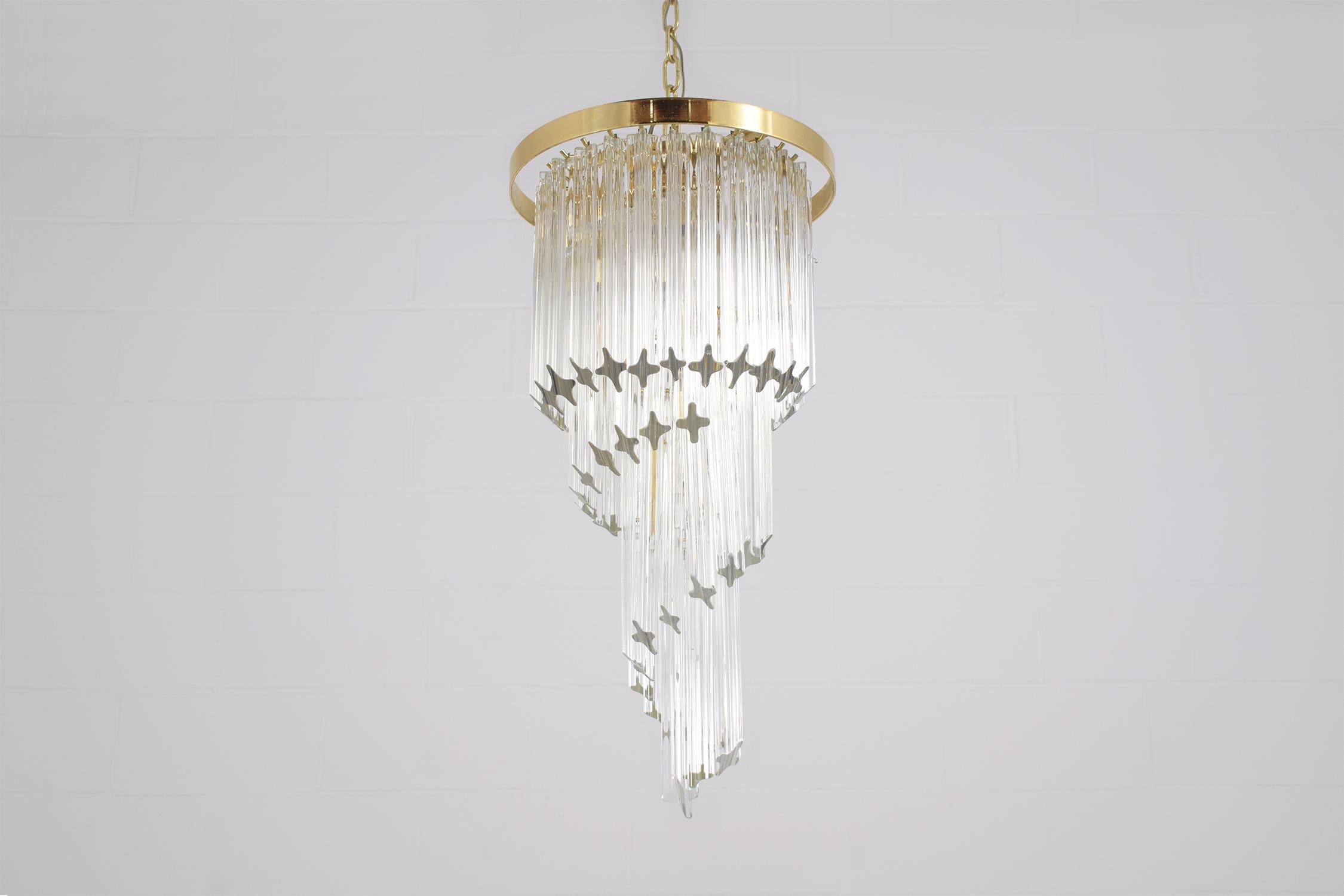 Add a touch of timeless elegance to your space with our vintage drop pendant chandelier, expertly restored to its former glory by our in-house team of skilled craftsmen. This exquisite light fixture is in great condition, showcasing the