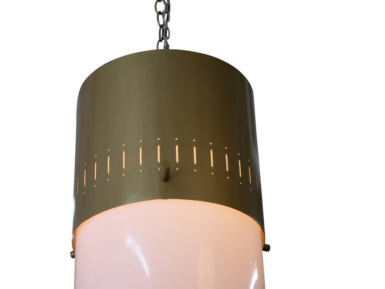 Vintage midcentury hanging lamp featuring a vented gold tone aluminum cap with a white acrylic cylinder shade. 

Price per light
4 lights available.