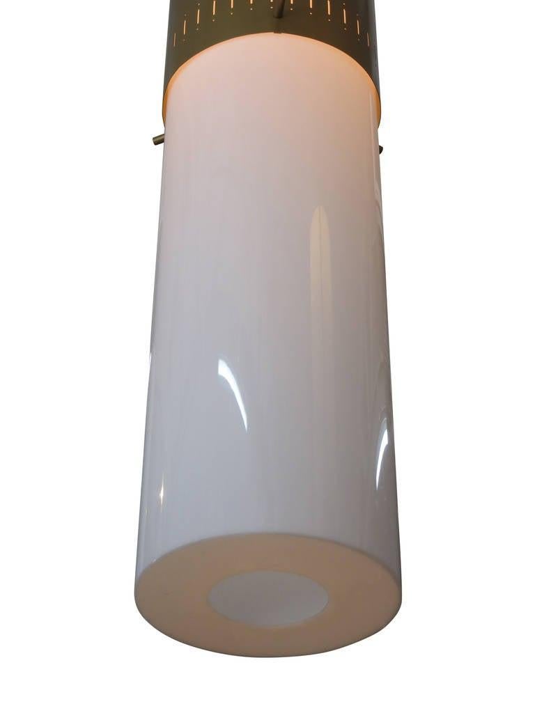Pair of midcentury hanging lamps featuring a vented gold tone aluminum cap with a white acrylic cylinder shade. Price per pair - 2 pairs available.