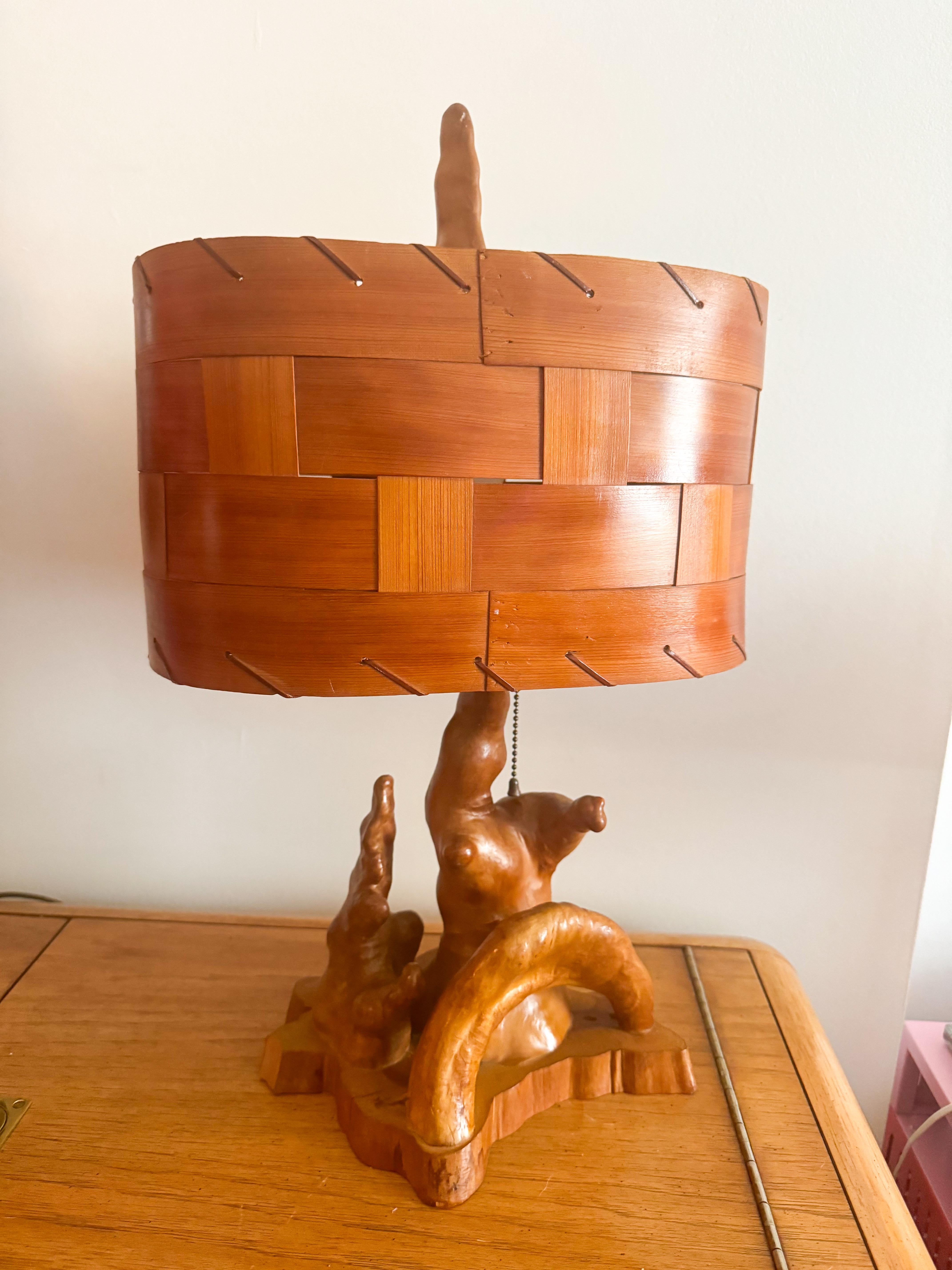 This unique Mid-Century Modern sculptural table lamp is crafted from natural cypress knees, organic outgrowths from the roots of the cypress tree, giving it a striking and earthy aesthetic. The base showcases the raw beauty of the wood with its rich
