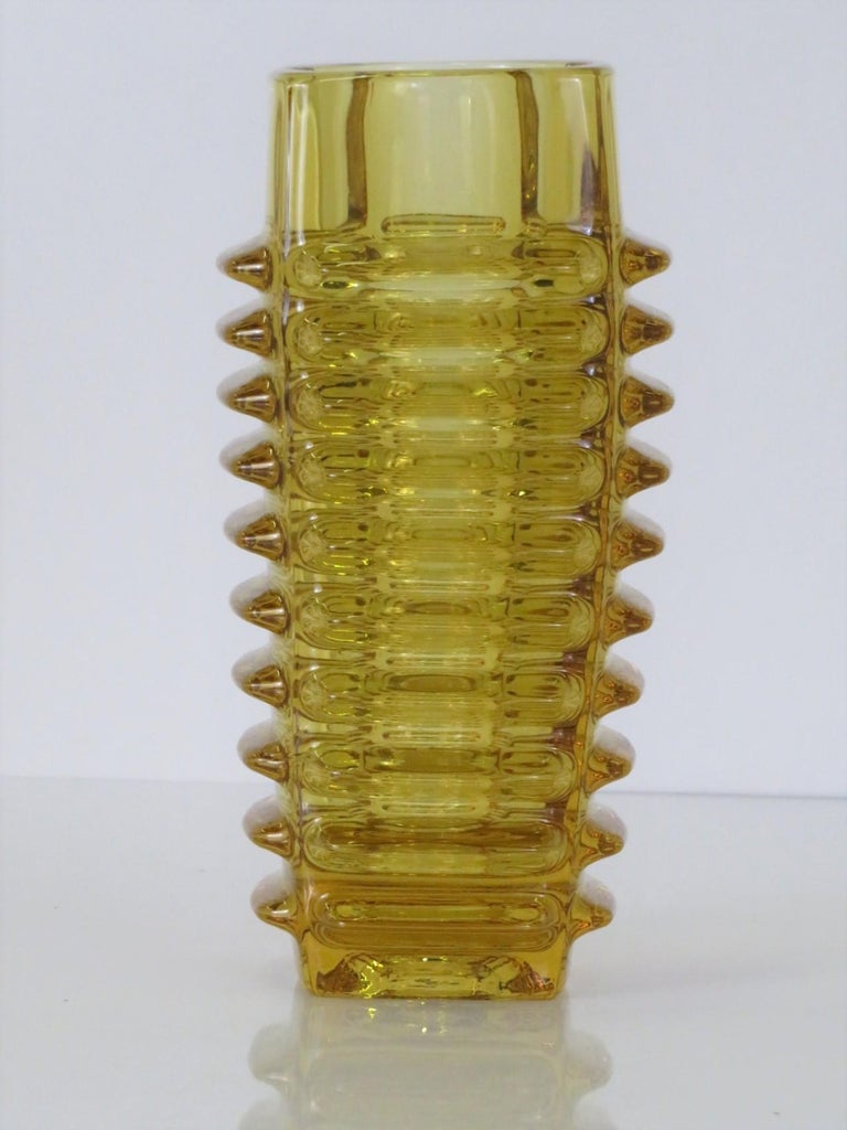 František Vízner (1936-2011) was one of the prominent Czech glass artists of the 20th. century. This beautiful piece #1102/20, in brilliant golden amber pressed glass, was created in 1963 at Sklo and consists of a cylindrical form encased by thick