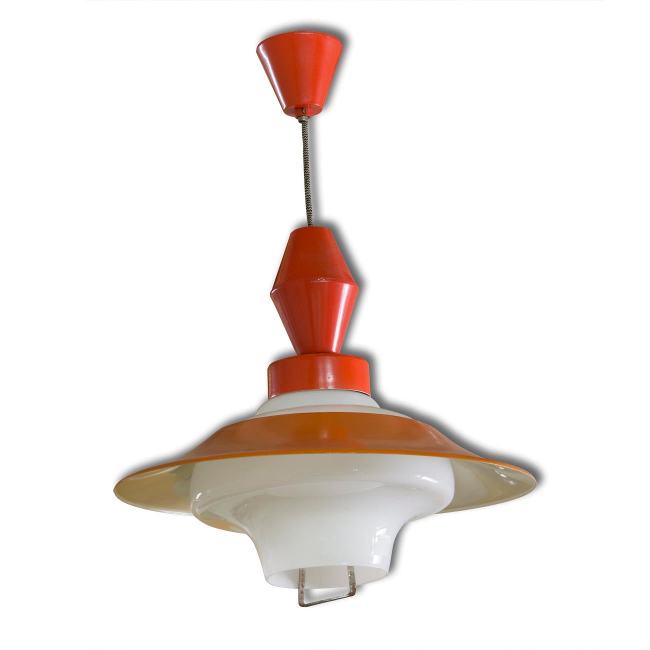 A vintage midcentury pendant light, made in Czechoslovakia in 1960s. In red with a white interior. Material: milky glass, metal, sheet metal. In good Vintage condition, consistent with age and use. New wiring. 


 