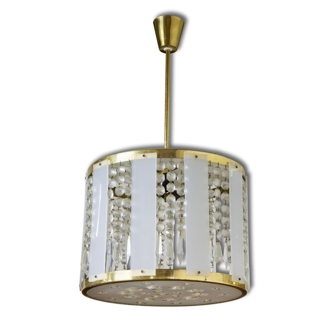Czechoslovak crystal chandeliers, made in the 1970s. An excellent quality piece, it features a cut glass beads and pendants hanging from the brass centre and slices of plexiglass around the chandelier. In very good vintage condition, consistent with