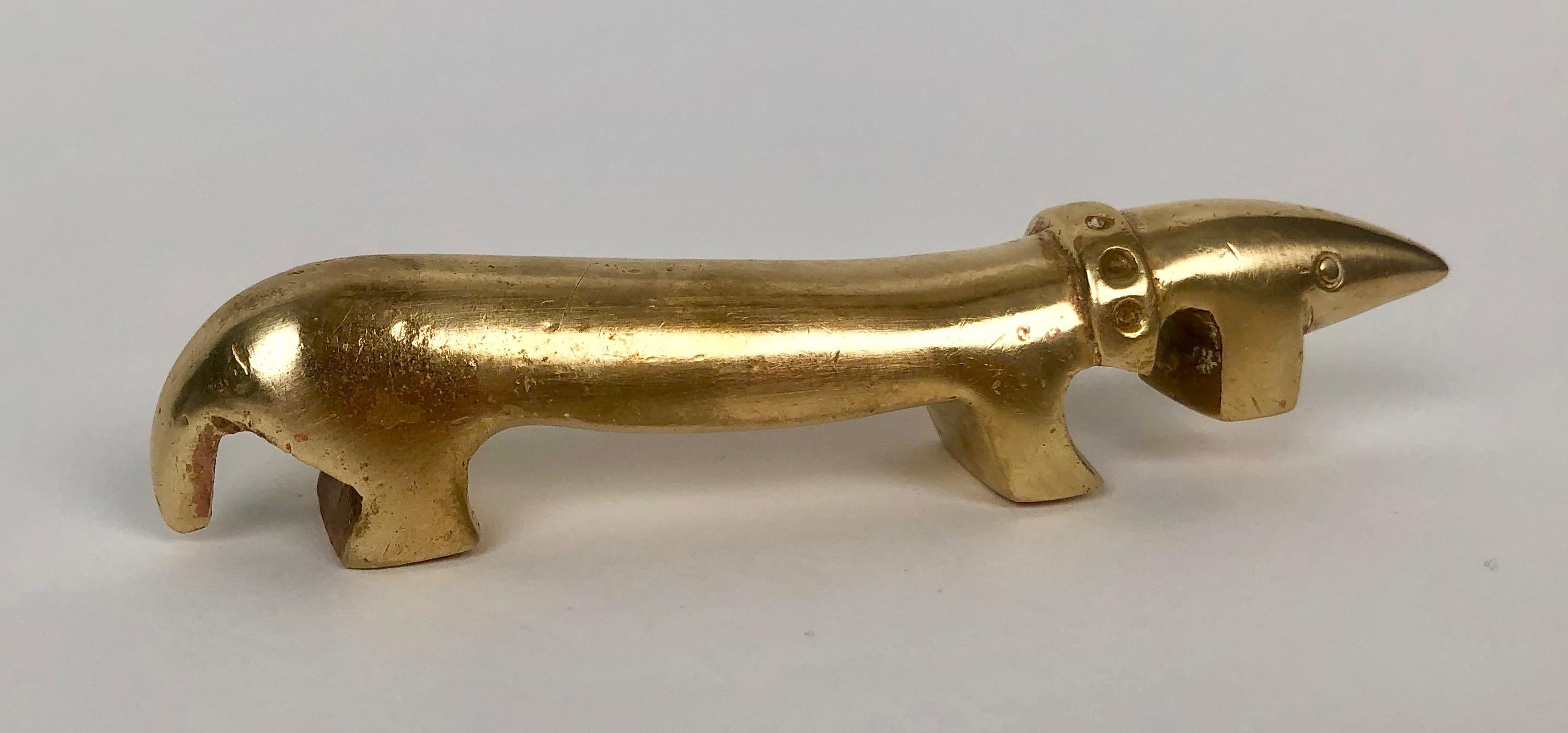 Charming mid-century bottle opener in the form of a Dachshund. 
Made out of solid brass, designed by Walter Bosse, produced by Herta Baller.
