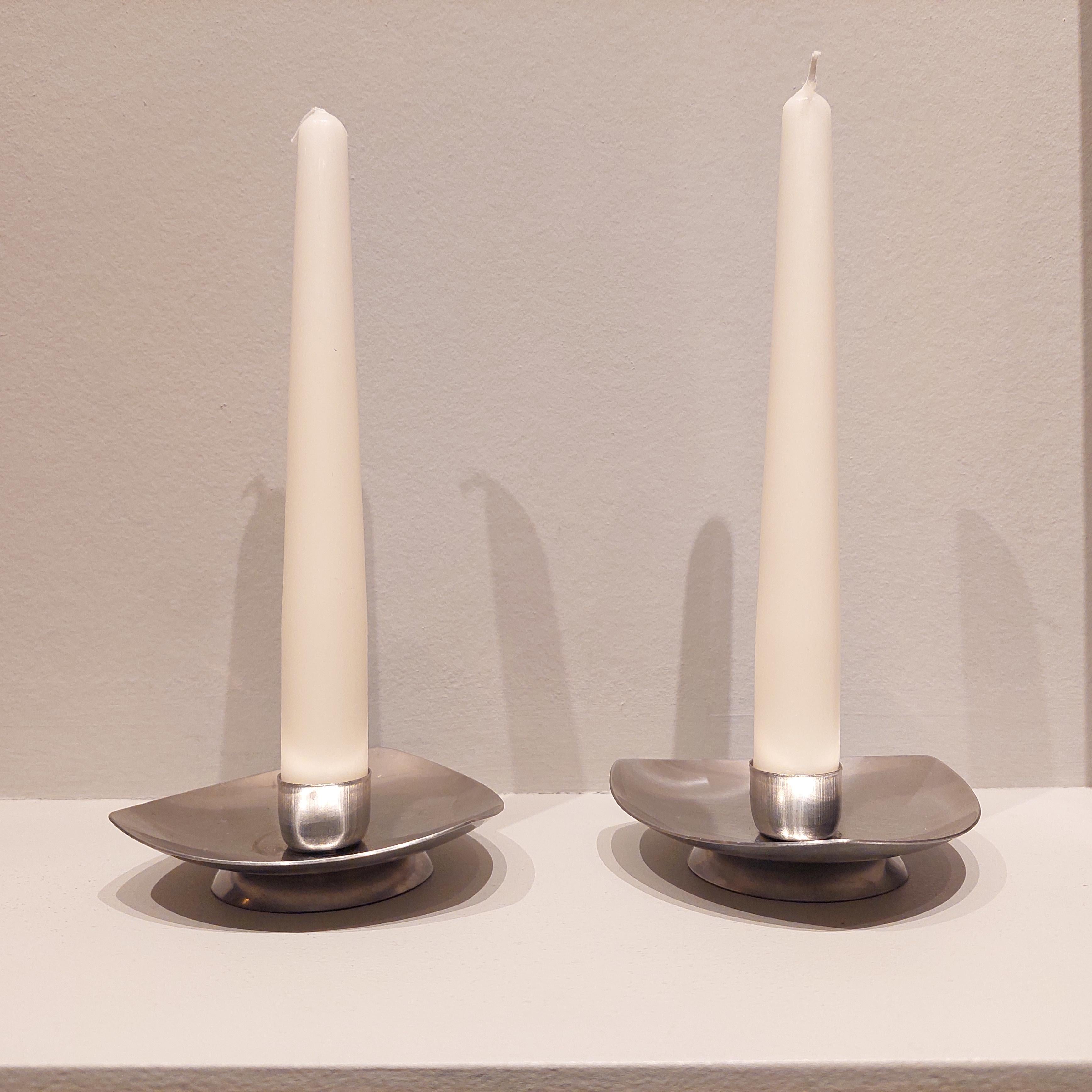 This is a set of 2  stainless steel candle holders from Denmark.
Triangular shaped candle holders.
Concave abstract rounded triangles, made off stainless steel with gorgeous silver color.
They stack nicely together if you like that that look. (see