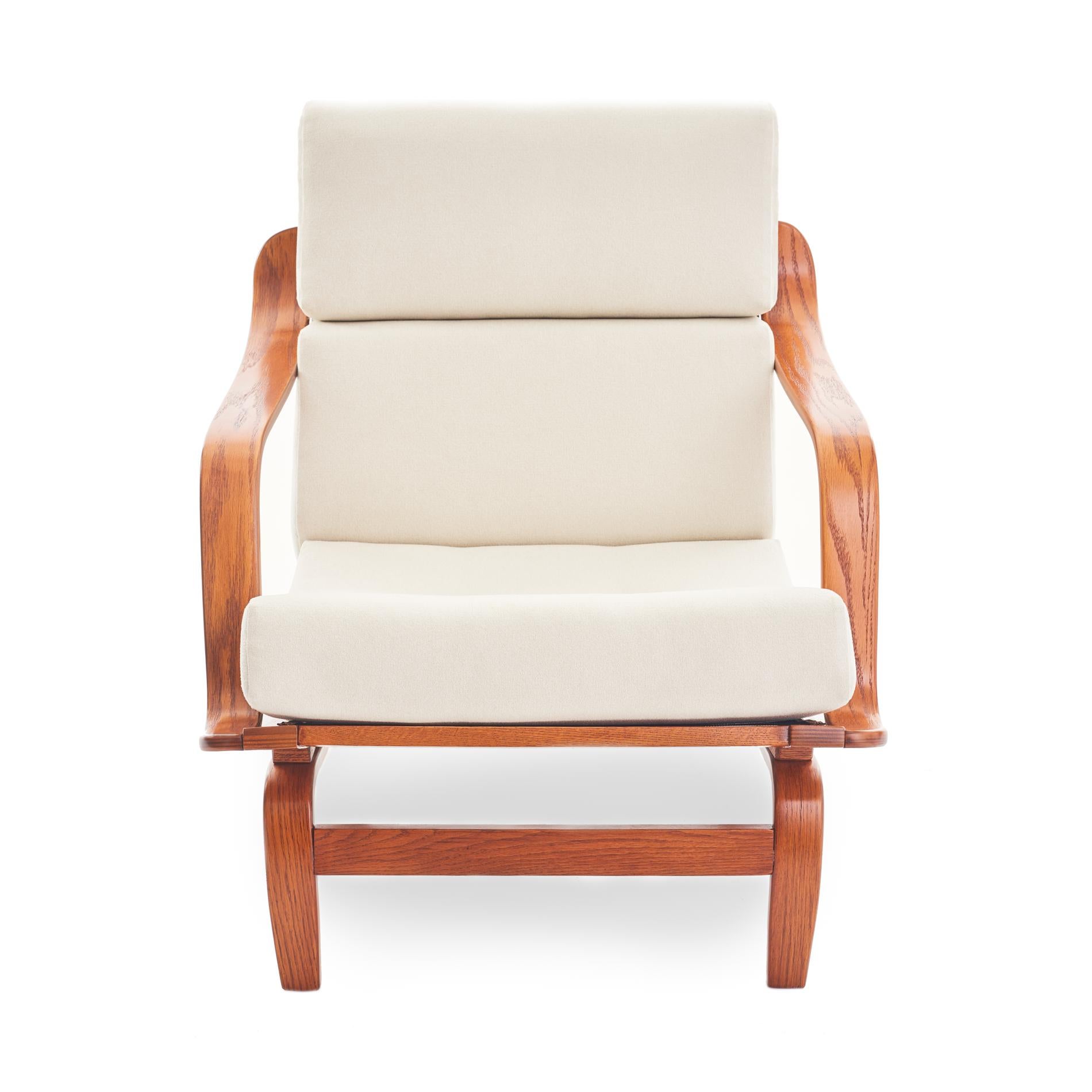 Svelte Danish or Scandinavian style bentwood lounge chair, with curvaceous arms and sculptural legs. Newly upholstered cushions feature a crisp cream flat wool fabric. This chair has been completely refurbished, and all joinery has been cleaned and