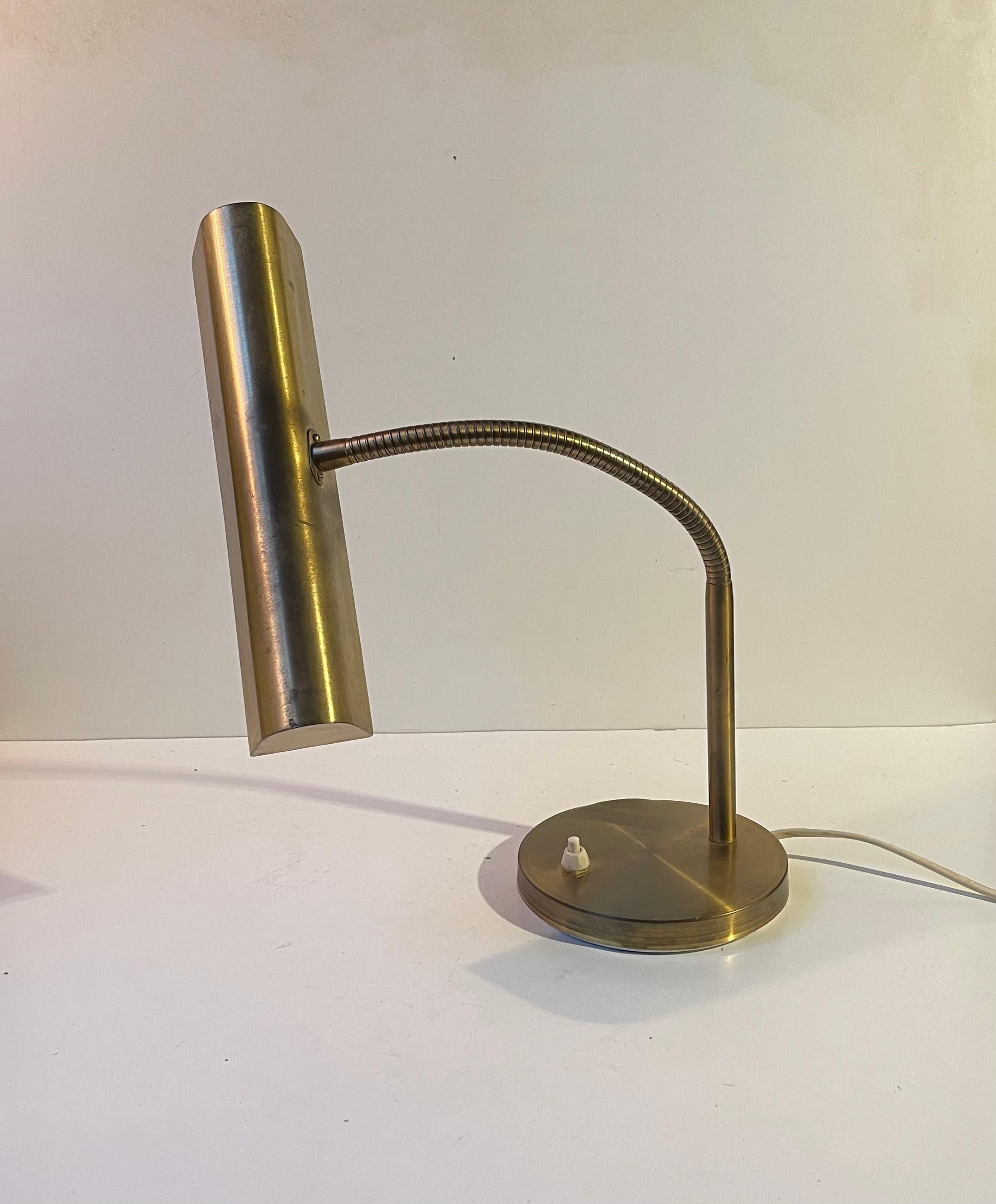 This midcentury danish bankers table light features two lightsources. Its made entirely out of brass and has a multi-adjustable gooseneck that allows you to direct the light in any direction. It was manufactured by E. S. Horn in Denmark during the