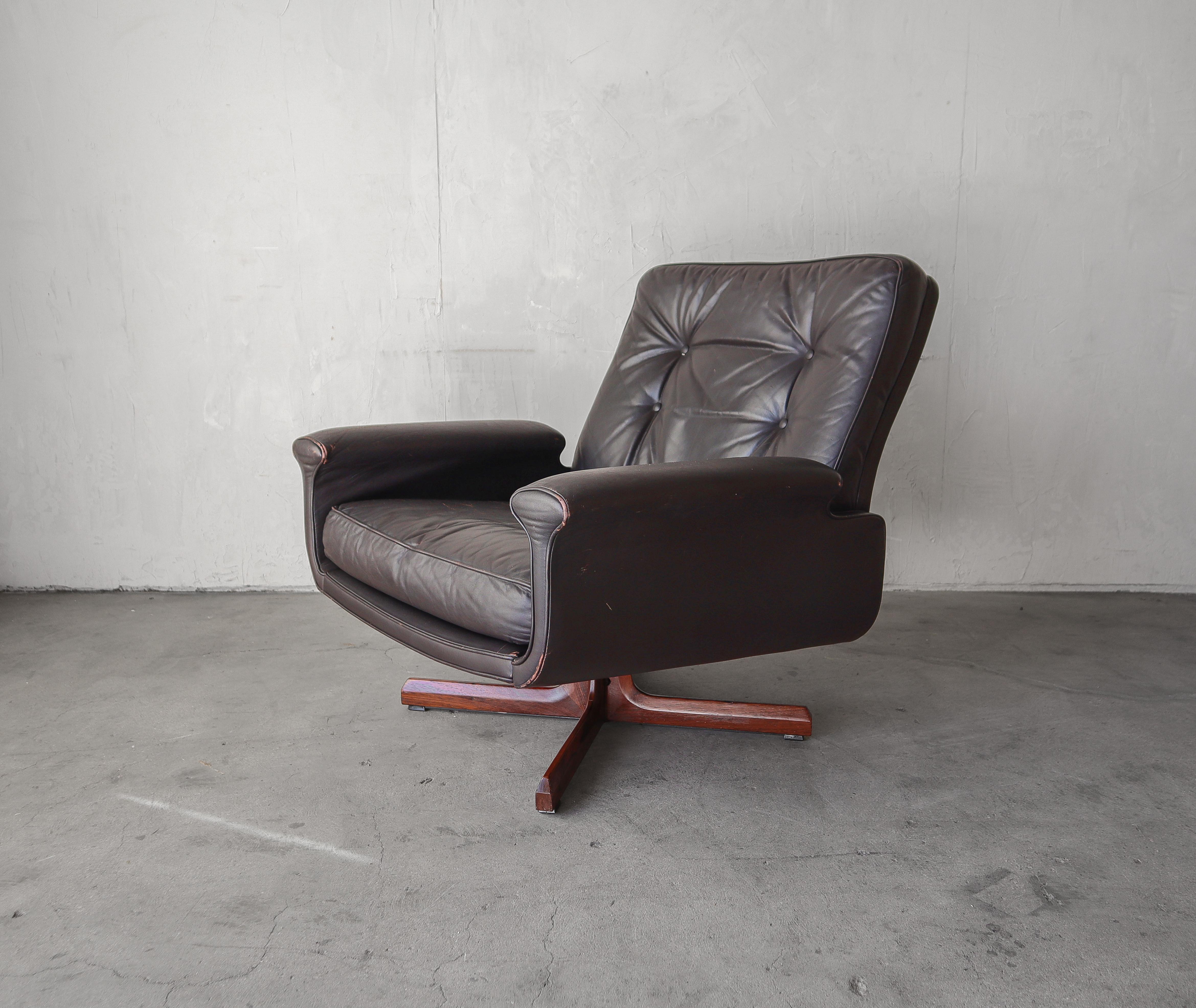 Simple Mid Century Danish Swivel Chair with an executive sort of feel.  

Chair is dark chocolate leather with a rosewood base.

Chair is well loved.  Leather shows some wear from age and use but it is free of any actual damage, see images.  Swivel