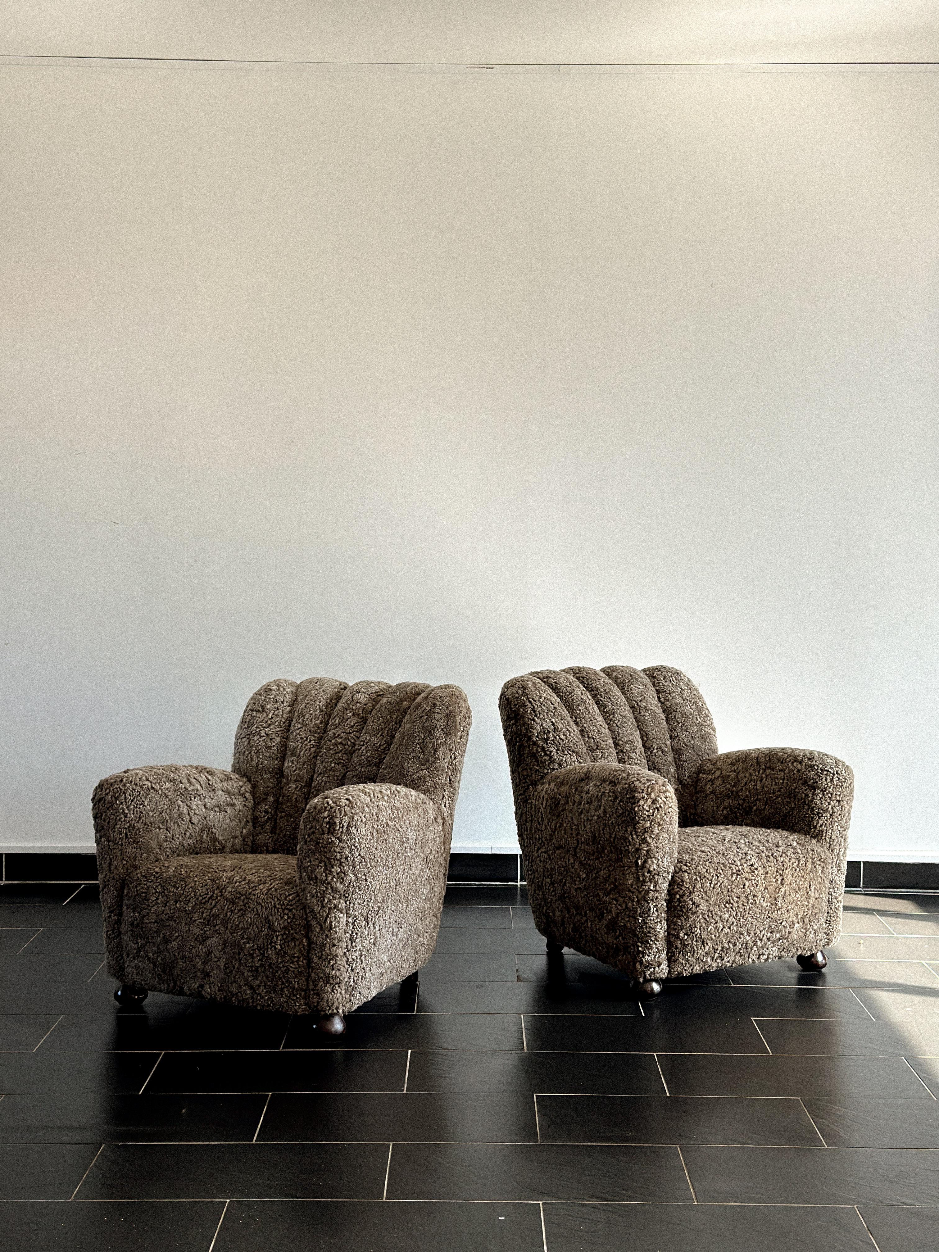 Mid-century Danish cabinetmaker lounge chairs from the 1940s, newly upholstered in soft brown sheepskin. Elegant craftsmanship with warm, organic comfort.