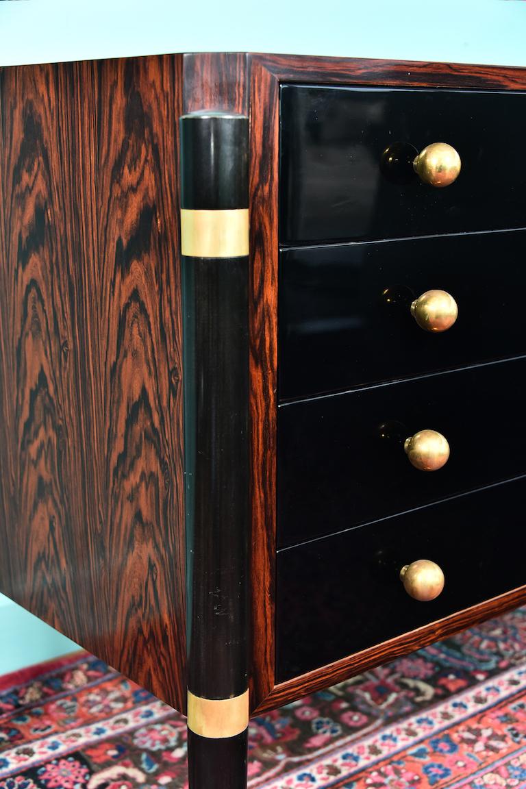 Midcentury Danish chests of drawers 
in palisander

 Chest of drawers is made out of fine palisander wood. It has 4 spacious drawers with gold round handles. There are 4 slim tapered legs with 2 gold decorative elements. Legs and front of the