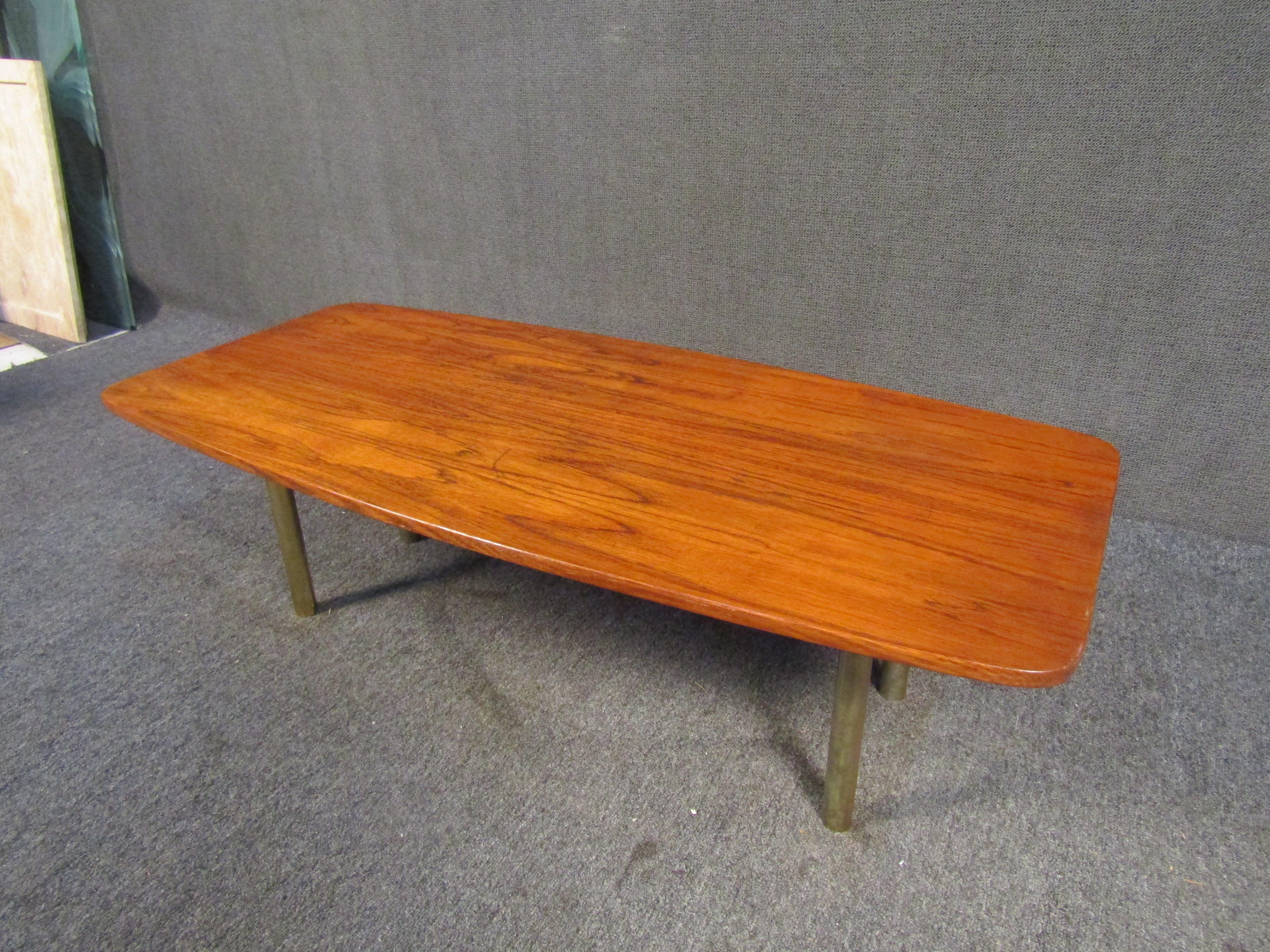 Mid-century Danish coffee table by Hugo Troeds. This table features a sleek modern design with an eye catching teak top and sturdy metal legs. A perfection addition to any living space.

 Please confirm item location with dealer (NJ or NY).