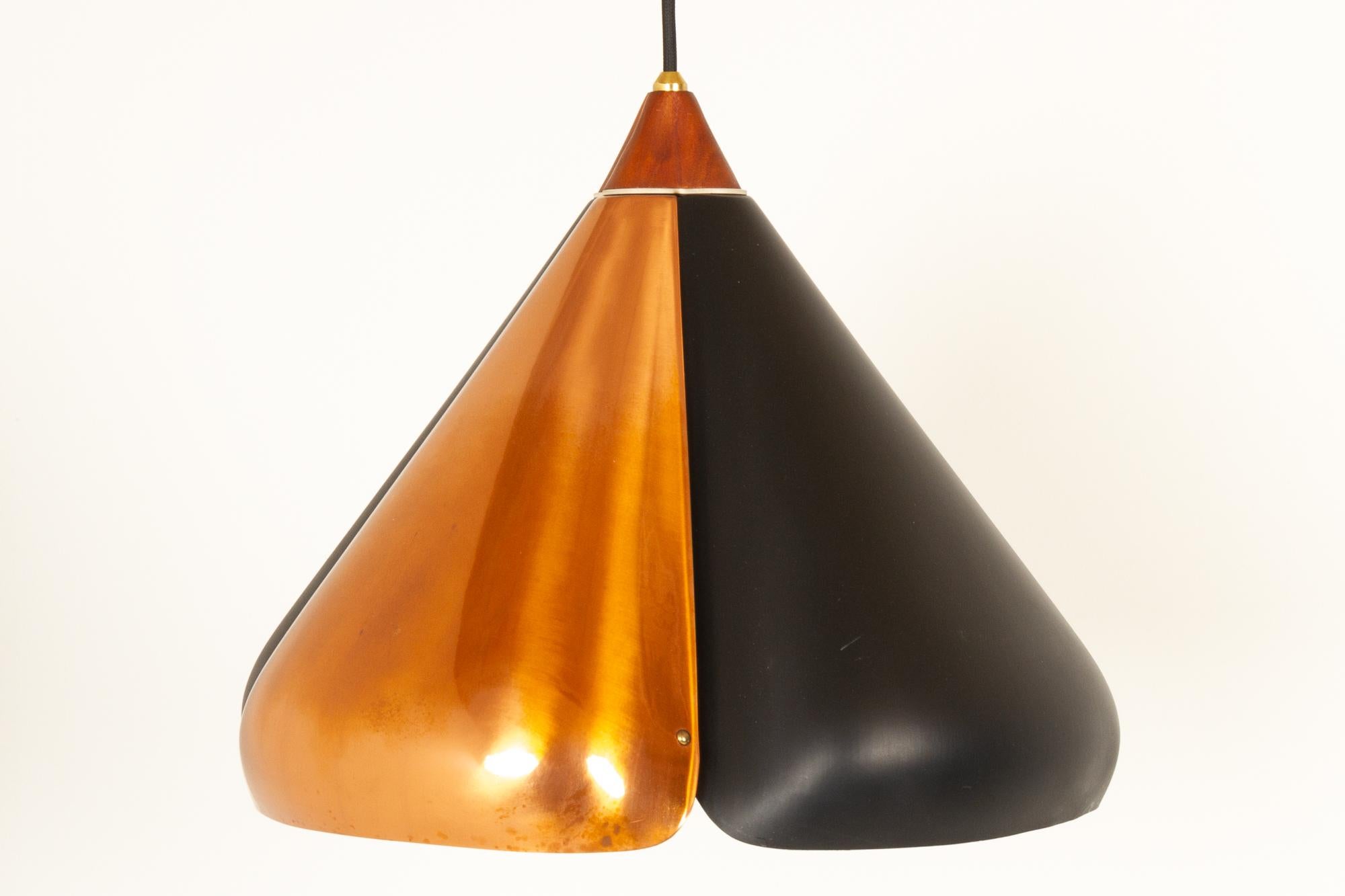 Midcentury Danish copper and black pendant 1960s
Vintage ceiling pendant lamp shaped as a four-leaf clover. Four shades connected by teak top. Fitted with a glass diffuser. 
Very good vintage condition. Fitted with new fabric wire. Only few signs